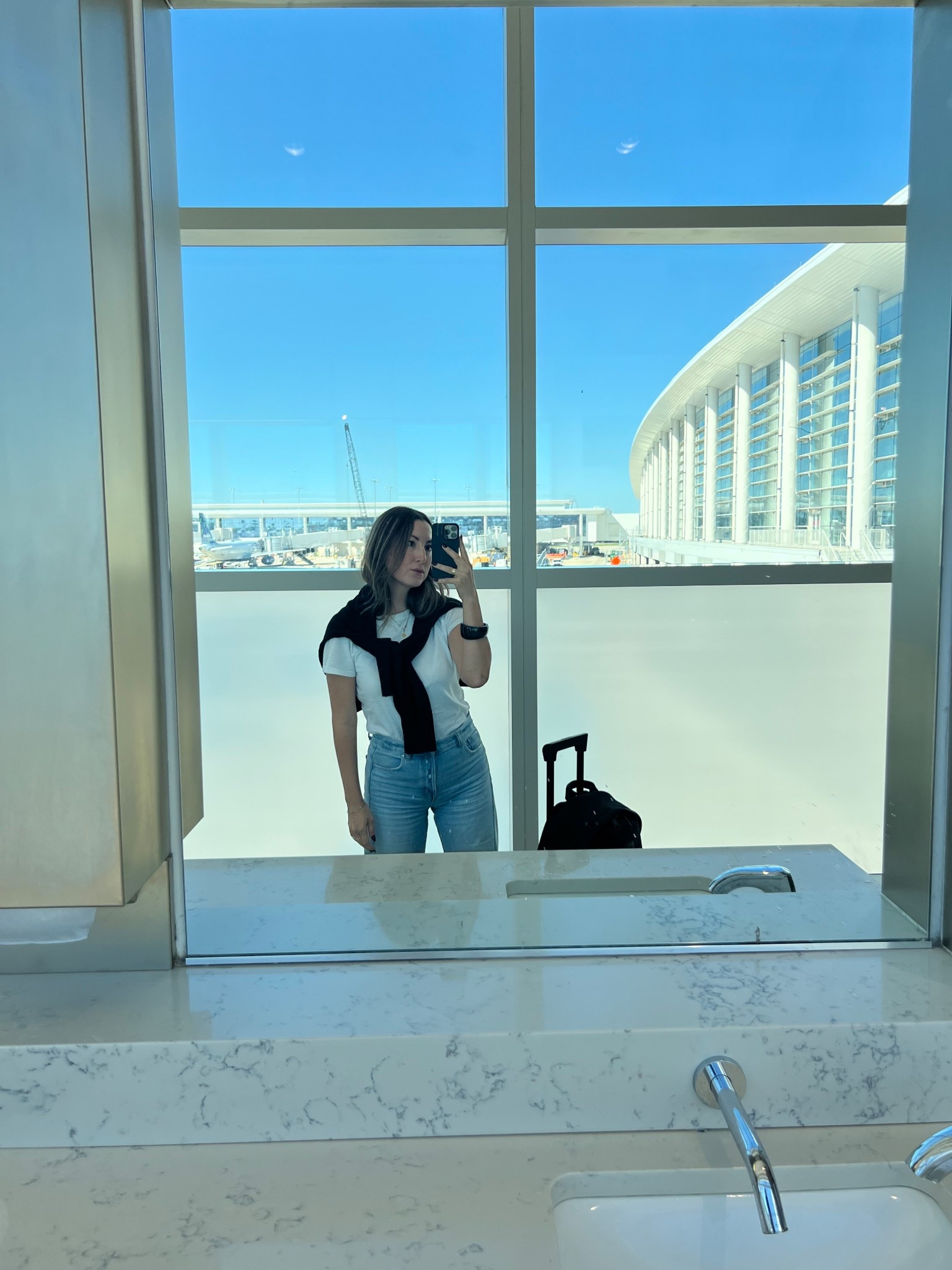 Amazon White T- Shirt + Old Navy V Neck Sweater ON SALE + Madewell Barrel Leg Jeans Light Wash Denim - Travel Outfit / Airport OOTD 

#LTKFindsUnder50 #LTKSaleAlert #LTKFindsUnder100