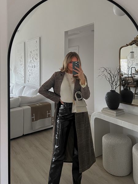 Patent leather pants, tall girl approved. White textured flare bell sleeve sweater too long sleeved. Check plaid long coat, brown checkered. Jacquemus le papier le chiquinto noeud beige shoulder bag.  

#LTKFind #LTKSeasonal #LTKsalealert