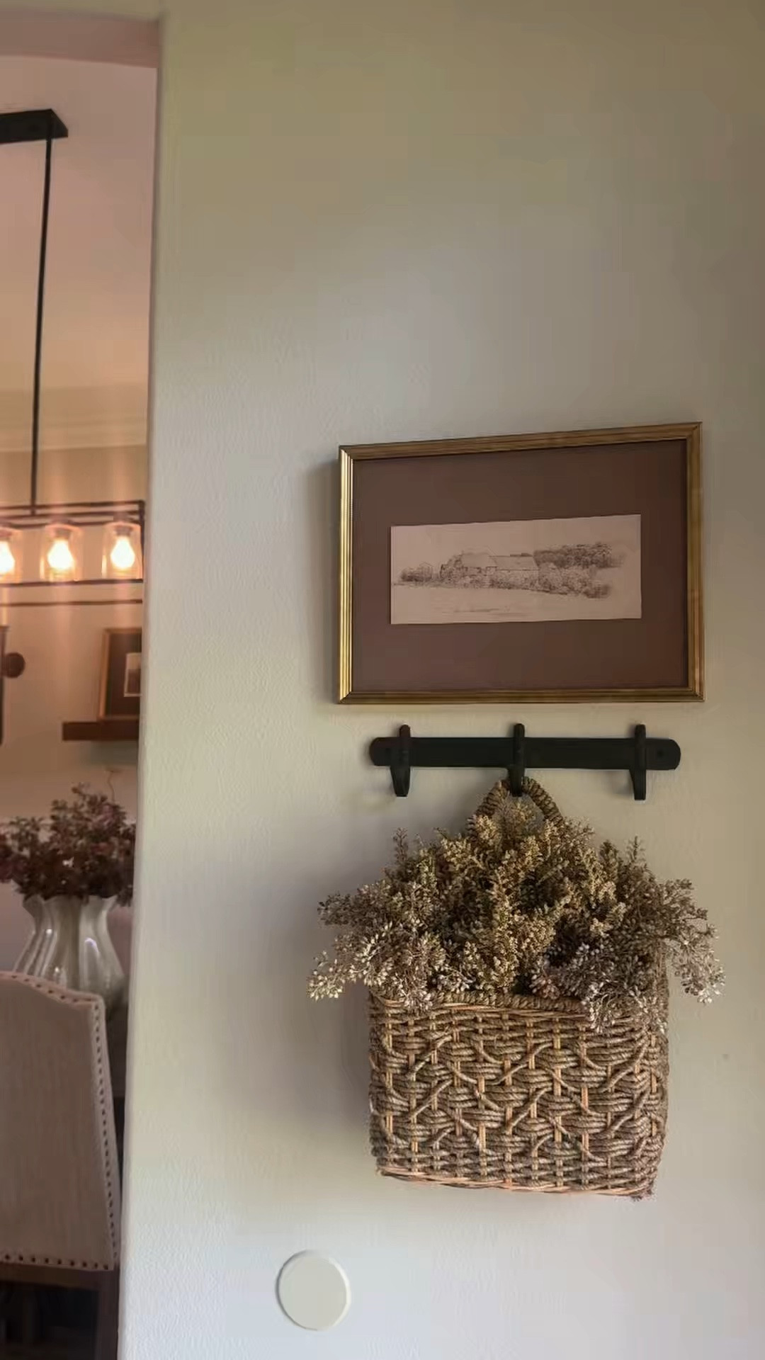 Turning a blank wall into the sweetest little moment 🤎 Everything I used is from Target! I love how the warm florals, woven basket, vintage-inspired art and black hook rail brought so much character and texture to this little spot.

#TargetFinds #TargetStyle #EntrywayDecor #NeutralHomeDecor #LTKHome