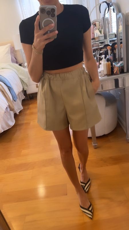 Faux tan leather shorts and a crop black top 