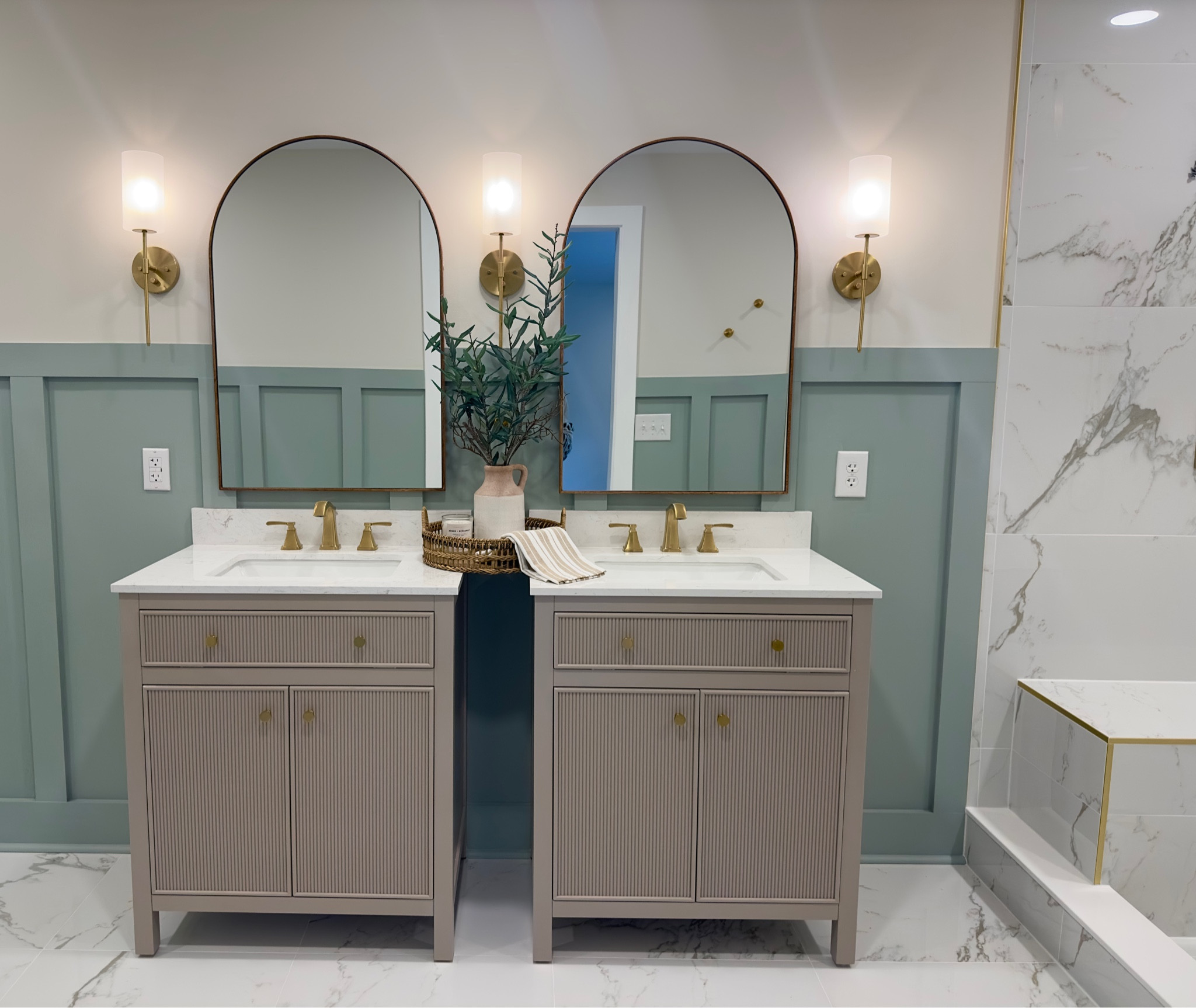 Primary bathroom / master suite / bathroom remodel / brown vanity / board and batten / sconce lights / tile floor / tile shower / gold faucet 

#LTKHome #LTKFindsUnder50 #LTKFamily