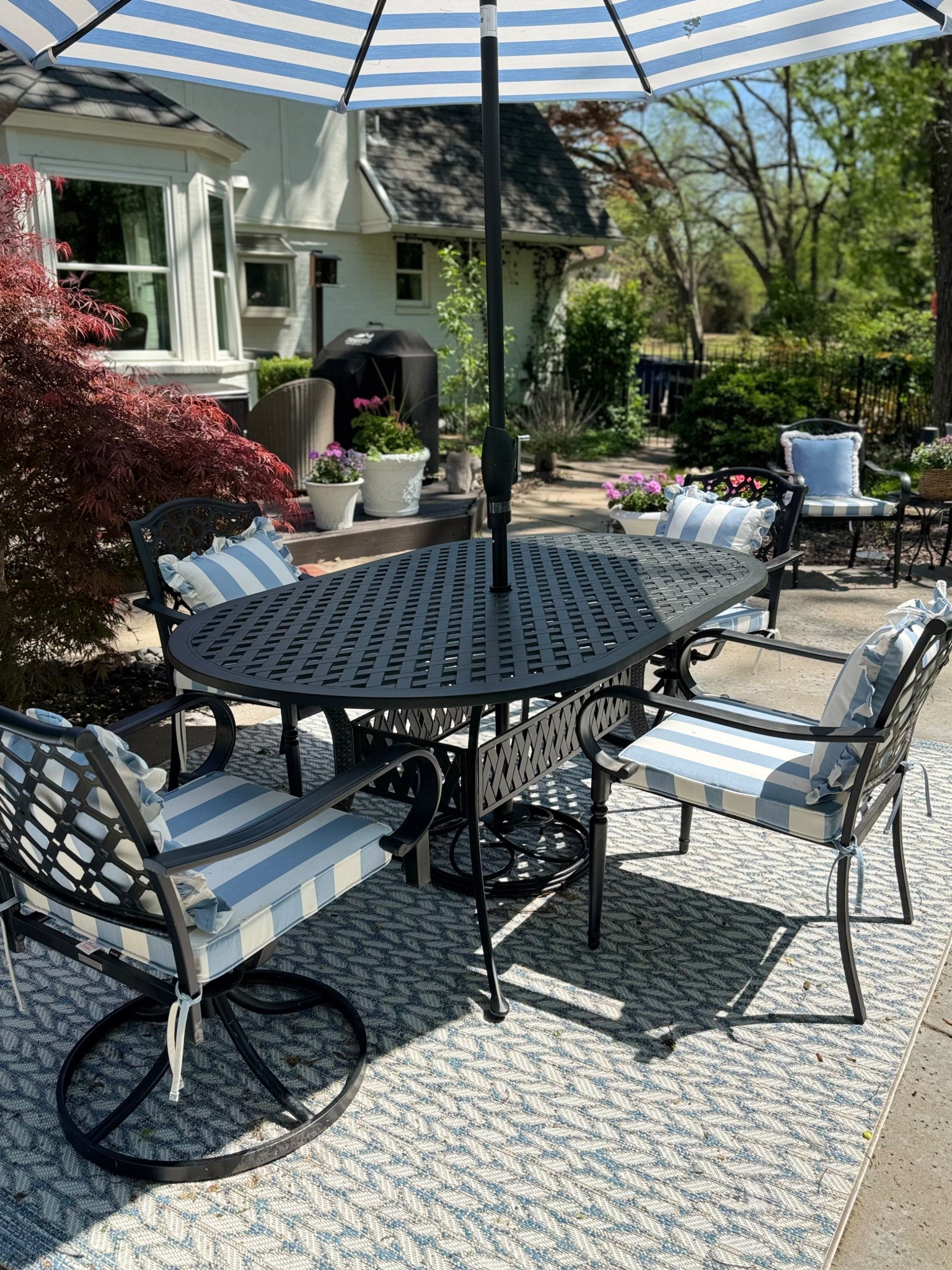 Outdoor patio decor, outdoor furniture, outdoor dining furniture, outdoor table, outdoor chairs, Sunbrella striped chair cushions, ruffle Sunbrella pillows, outdoor rug, Sunbrella patio umbrella 

#LTKSaleAlert #LTKHome #LTKSeasonal