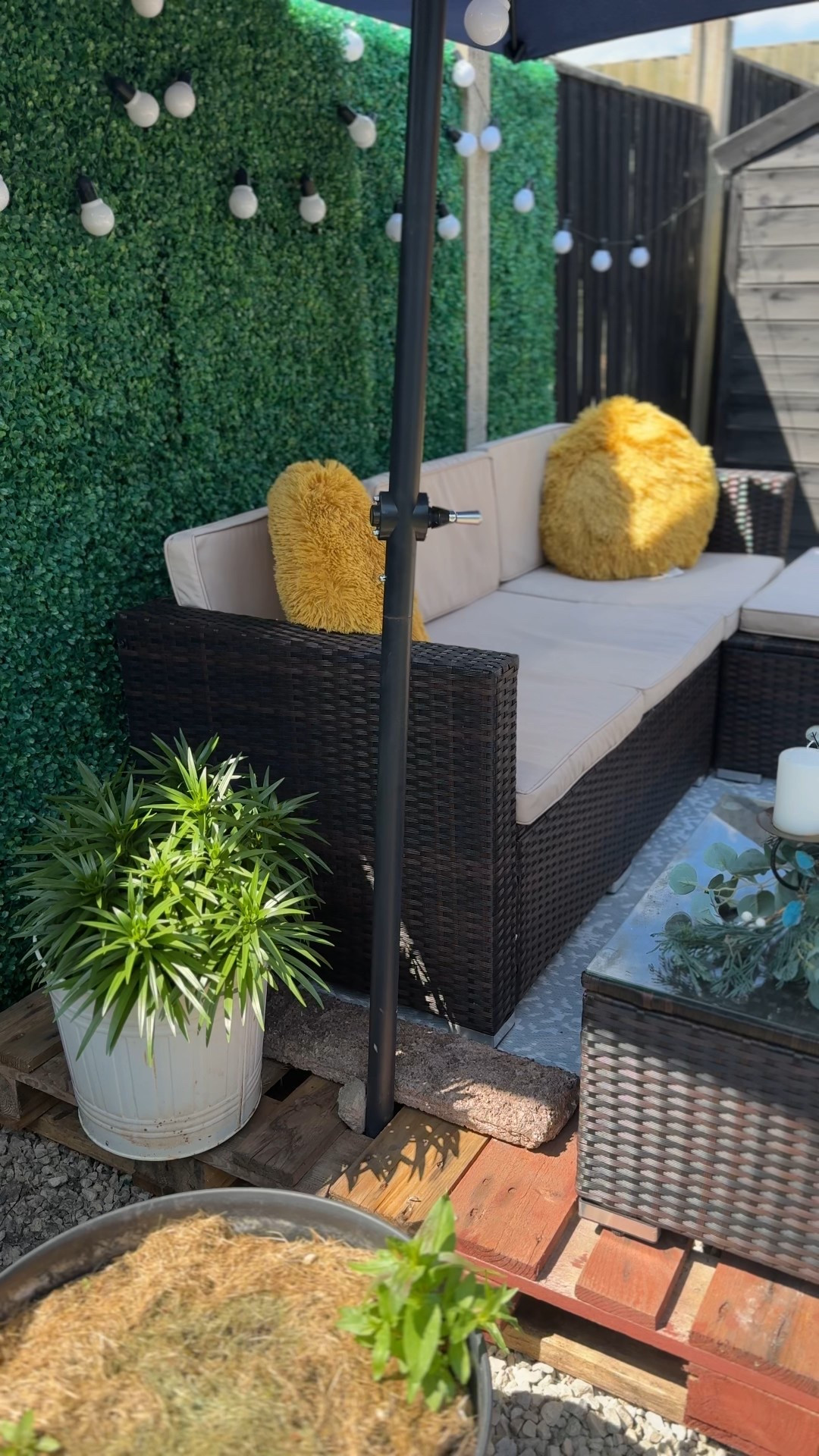 I am an outdoorsy kinda gal. Give me sunshine. Give me plants and a body of water, and I am GOOD! 

This patio set was quite easy to assemble. It was easier putting it together with my daughter, though.  

For this post, I suggested two decorative cushions that could work  because the ones here are no longer available. I strongly encourage you to use ScotchGuard to waterproof the fabric.

You could use some on the patio set’s cushions, but that’s not necessary.

If you get the umbrellas, get the stand, too. It is worth having. 

The green backdrop comes in squares that you click in place together, and the solar lights work magically at night. The whole set up brings that space to life!

Do you think I should stain the pallets?


#LTKSummerEdit #LTKFamily #LTKHome