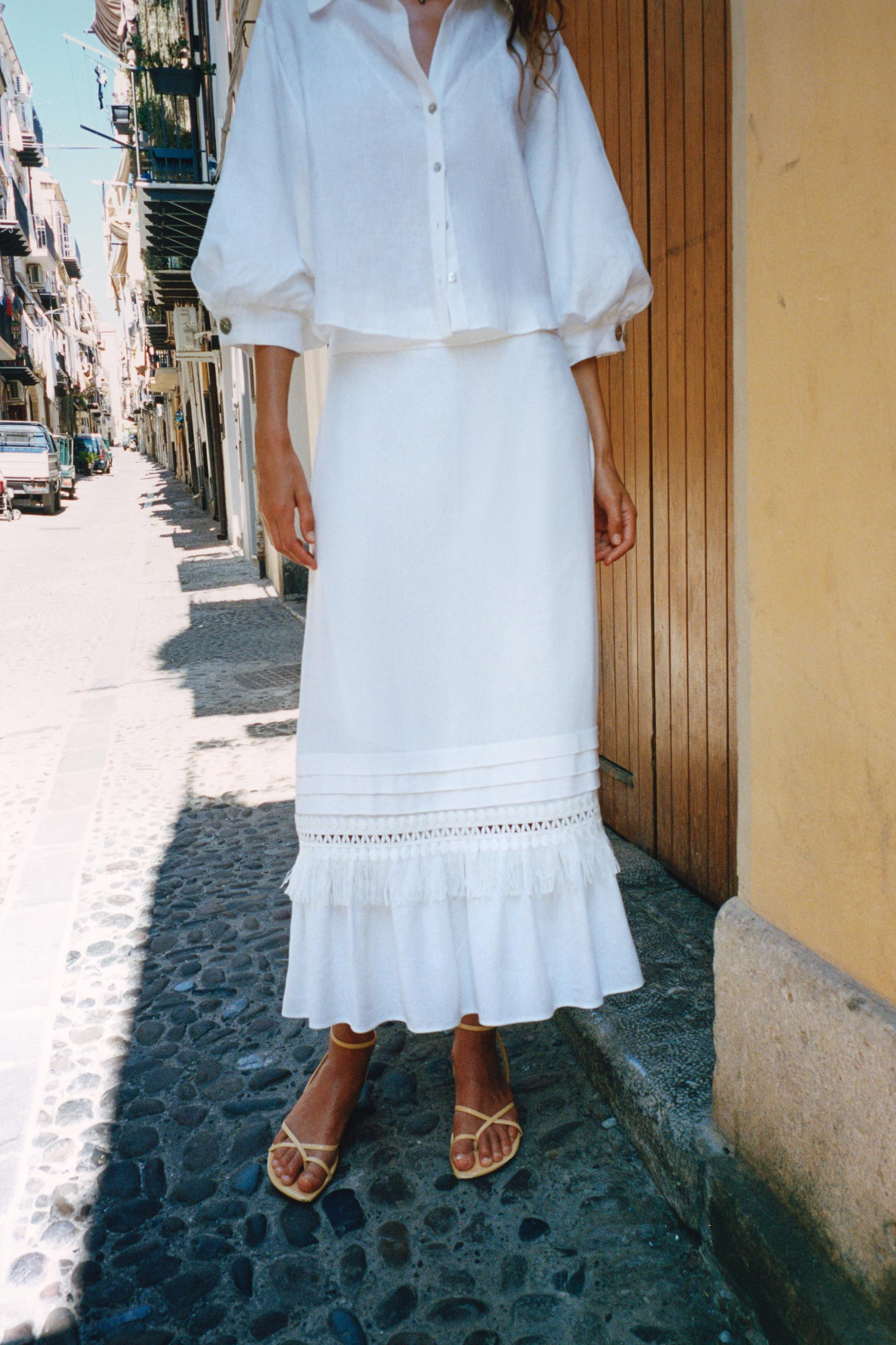 Midi skirt made of linen. Hem with pleats, fringe, and ruffle details. Lined. Side hidden in-seam... | Zara US