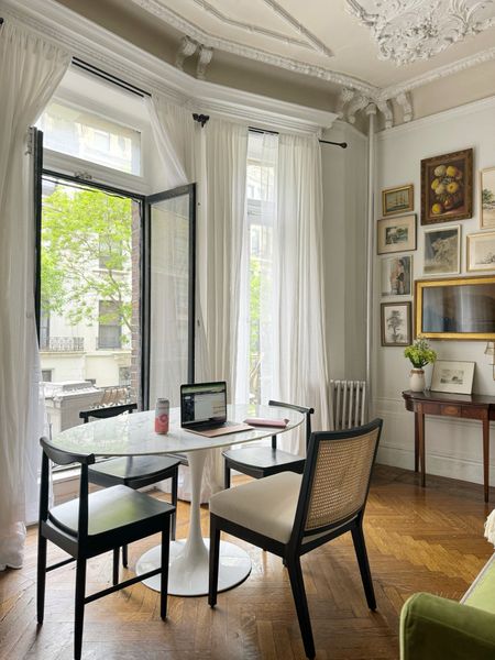Dining set up- white marble tulip table, black wooden dining chairs, console table, white linen curtains, sheer curtains

#LTKHome