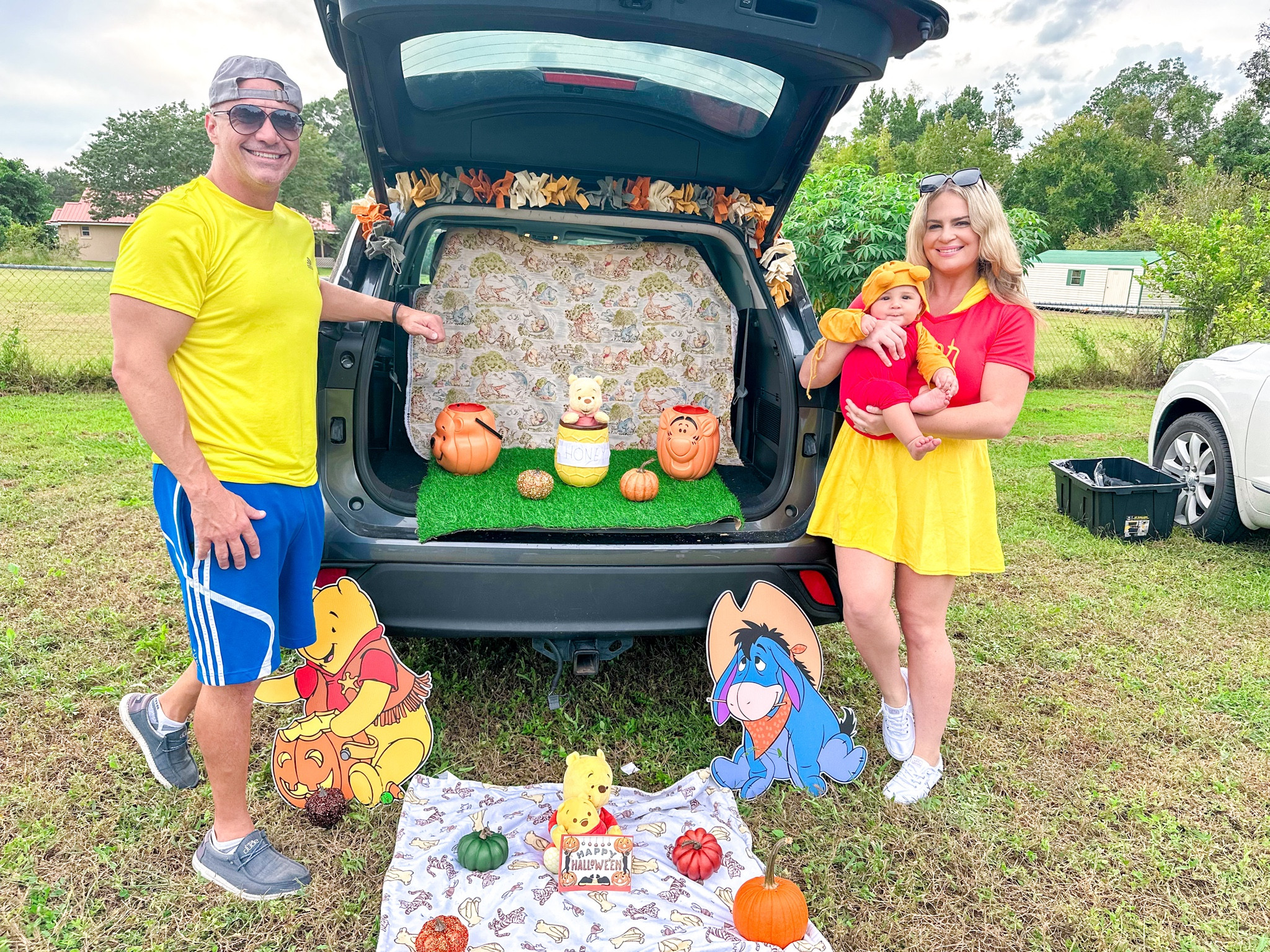 
Winnie the Pooh Trunk or Treat! This was so much fun to create. I did use a lot of items that I already had.

I bought the Winnie the Pooh fabric and grass at hobby.

We live Florida so I wanted a Winnie the Pooh costume for my son that was light weight. This one was perfect! He is 7 months and I got him size 12-18 months so he can wear it for a while.

I am wearing a size large in my costume and so is Romper. I have 5 ft 10
 The large was slightly tight on Romper but not too bad…they didn’t have an Xl. He weighs about 75 pounds.  

My husband used clothes that he already had for Christopher Robin.

Winnie the Pooh Halloween costume 
Winnie the Pooh Halloween costume for baby
Winnie the Pooh Halloween costume for dog
Winnie the Pooh onesie
White sneakers 
eeyore costume for dog
Family costume idea
Matching costume
Matching costume with baby
Matching costume with dog
Matching theme costume 
Trunk or treat theme
Winnie the Pooh trunk or treat 

Winnie the Pooh, Tiger, Piglet, Eeyore Halloween cutout and yard sign
Winnie the Pooh Walker 
Winnie the Pooh stuffed animal
Winnie the Pooh blanket 
Winnie the Pooh baby shoes
Christopher Robin Halloween costume 

#LTKHalloween #LTKbaby #LTKHoliday