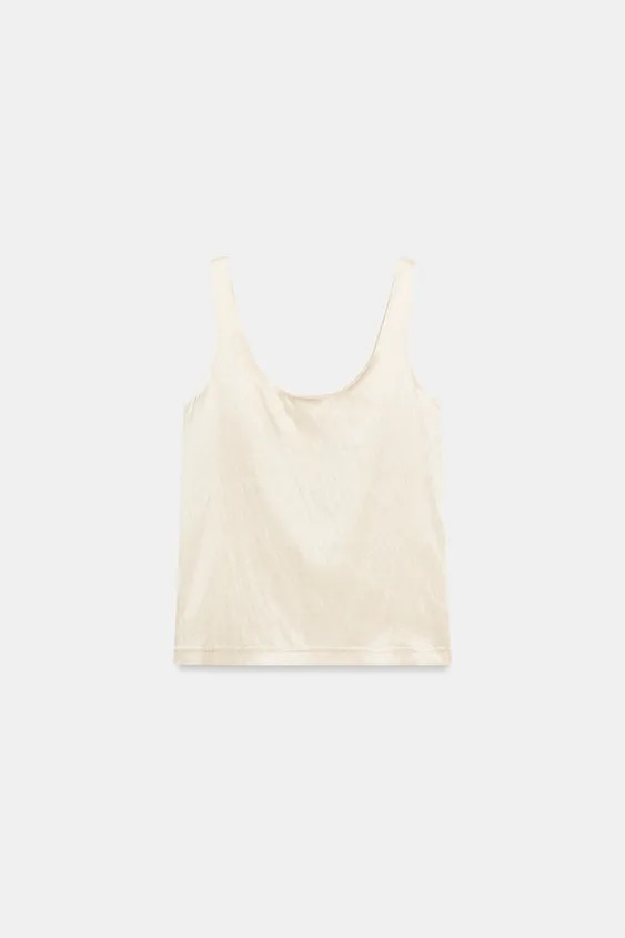 Top made of satin fabric. Features a round neckline and straps. | Zara US