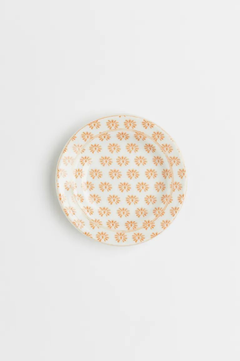 Small dish in porcelain with a printed pattern at top. Diameter 3 3/4 in. | H&M (US + CA)