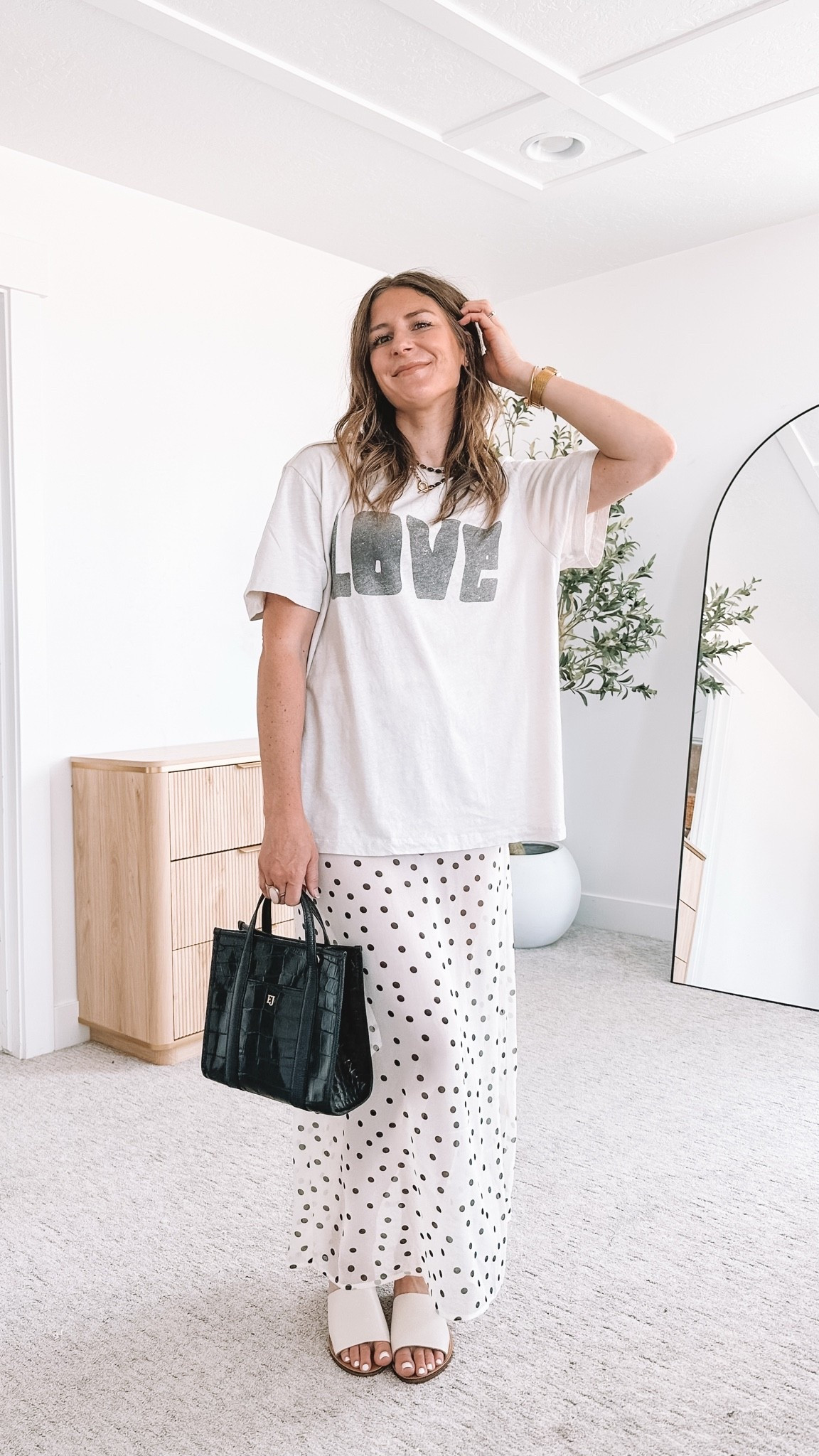 Proof that easy and cute are not opposites. I threw an oversized LOVE graphic tee over a flowy polka dot maxi skirt and styled it with a structured black tote and simple white slide sandals. It is the kind of outfit you can put on in seconds and feel put together in all day long, comfortable enough for real life but cute enough to feel like yourself.

#LTKmomlife #LTKootd #LTKgrwm