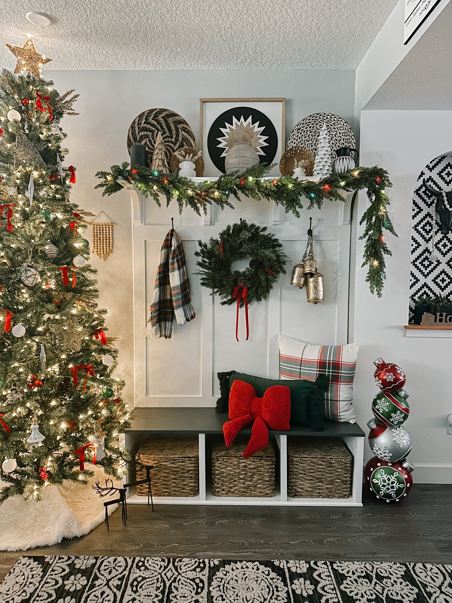 Classic green tree with red and green decor pops of wood and white, red bow pillow on top of velvet fringe lumbar, and large plaid white square with red and green pops. My garland is @afloral sharing end of week, used multi colored lights since tree has both white and multi. Linking all items shown, red velvet bow was ribbon I tied #christmas #christnasdecor #christmaspillows #cedargarland #christmaslights #walmart #afloral #redbows #bowpillow #redbowpillow #plaidpillow #christmaswreath #holidaybells #plaidscsrf #winterdecor

Mudroom entryway holiday decor. Plaid and red velvet bows, cedar garland, multi colored lights, slim tree #greenfauxChristmastree

#LTKSeasonal #LTKHoliday #LTKHome