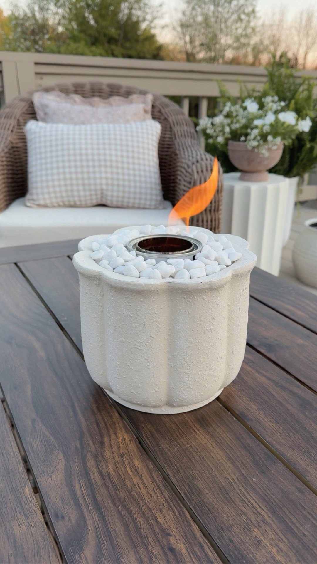 This mini DIY tabletop fire pit took less than 5 minutes to make and adds so much ambience to my outdoor setup. The gel fuel canister lasts around 3 hours and makes a lovely crackling noise — just like a real wood burning fire! When the gel is gone, simply replace with a new canister. I bought these in bulk so we’ll have them on hand all summer. 🔥

Steps:
1. Add a layer of rocks to the bottom of your planter to create a base for the gel canister. 
2. Add canister, ensuring it’s sturdy. 
3. Fill in empty space with large river rocks (I grabbed mine from my garden). 
4. Finish with a layer of fine white river rocks (these are from Walmart). 
5. Carefully remove canister lid, light with a stick lighter and enjoy! 

#LTKHome #LTKSeasonal