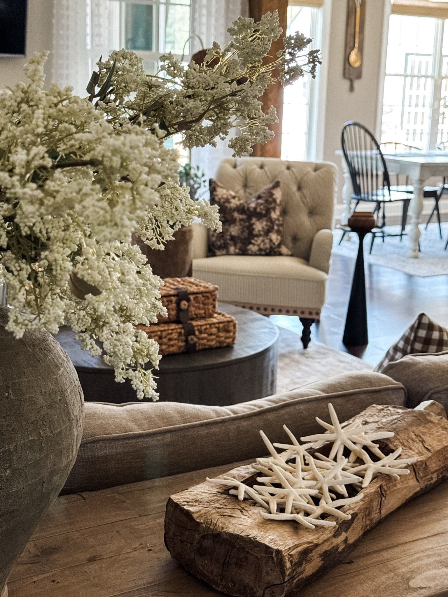 Summer Living Room with Coastal Touches💙🐚
Vintage and coastal style go together beautifully. I love layering my coastal decor with vintage finds during the summer months. 

vintage wood tray, console table, starfish, woven storage boxes, round coffee table, throw pillows, pillow inserts, floor lamp with woven shade, taupe vase, white berry stems, upholstered side chair, black drink table, dining room table, dining room chairs

#LTKstorytime #LTKSeasonal #LTKHome