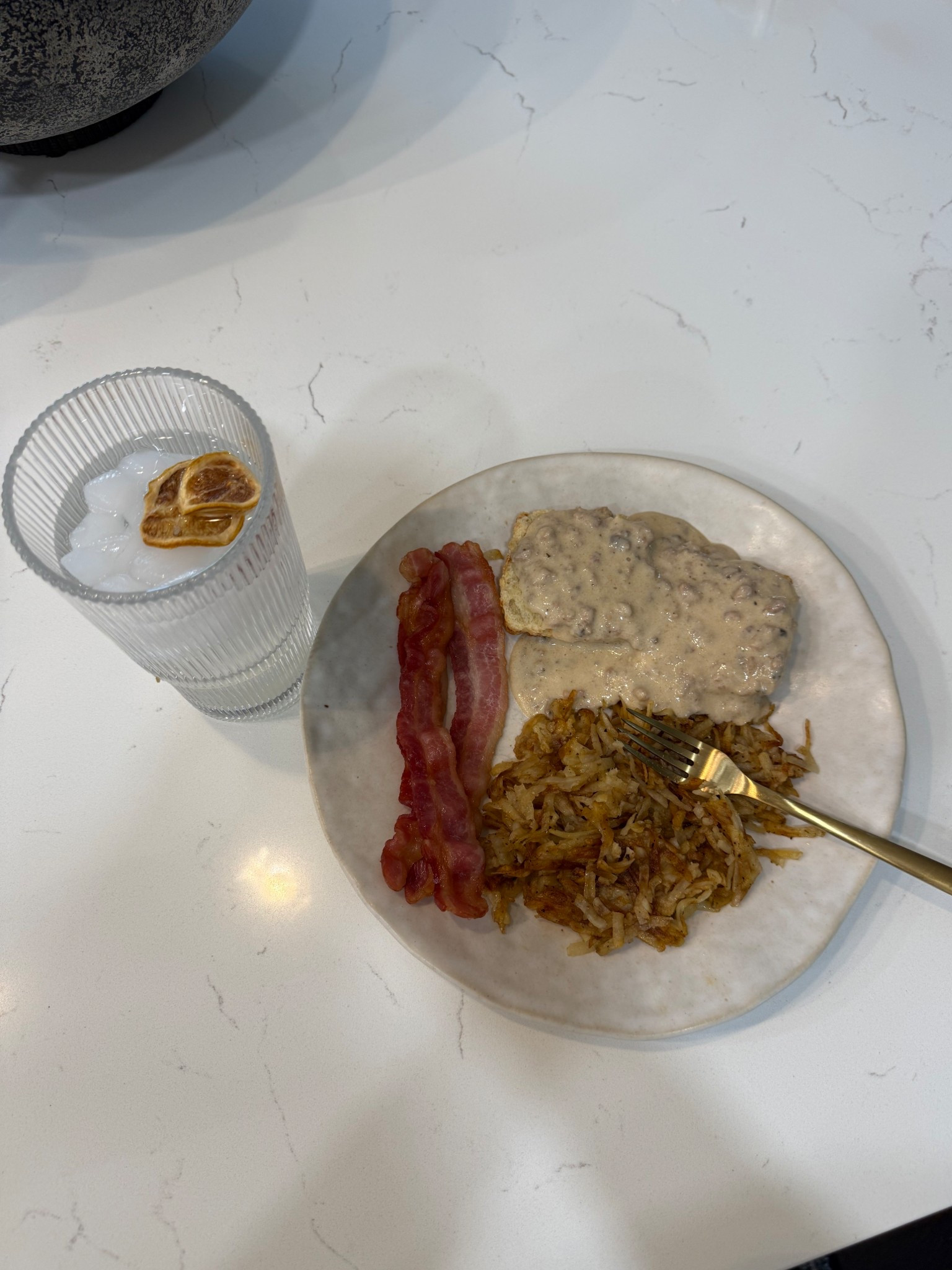 Breakfast for supper is always a favorite in our house!

Center cut bacon, homemade sourdough biscuit, homemade sausage gravy, and homemade hash browns!  Water with dried lemon slices  All for just under 500 calories 🤍🤍🤍

#LTKfitnessgoals #LTKvlog #LTKfoodie