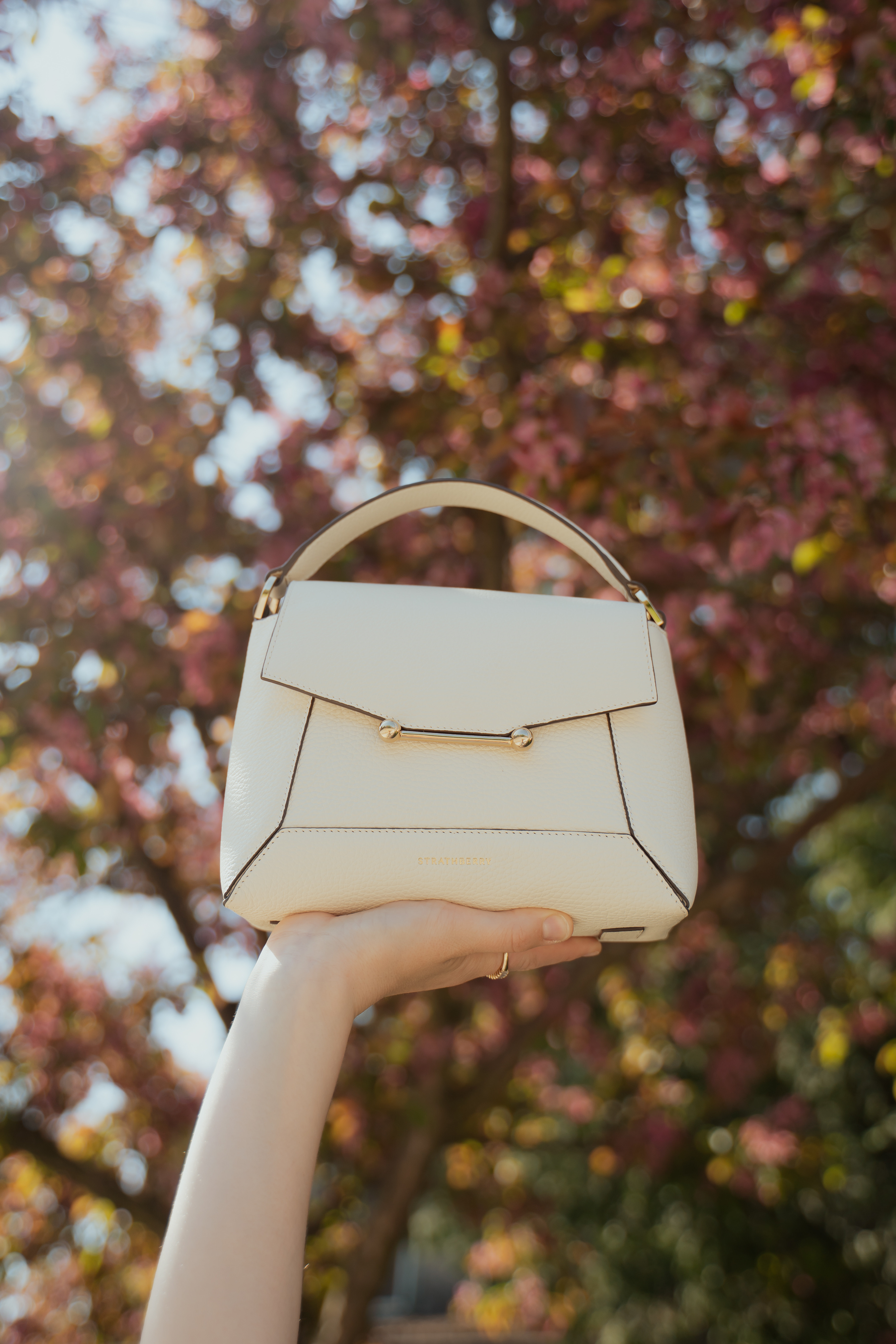 My first Strathberry and I am absolutely obsessed 🤍✨ The Mosaic Bag in Vanilla is everything. 100% handcrafted calf leather, that dreamy gold music bar hardware, and it fits more than you'd think (phone, wallet, keys, perfume... yes really). Wear it as a top-handle or crossbody for the ultimate spring/summer versatility. This one is a forever bag 🫶  

 #LTKcanada #LTKsummer #LTKbag
