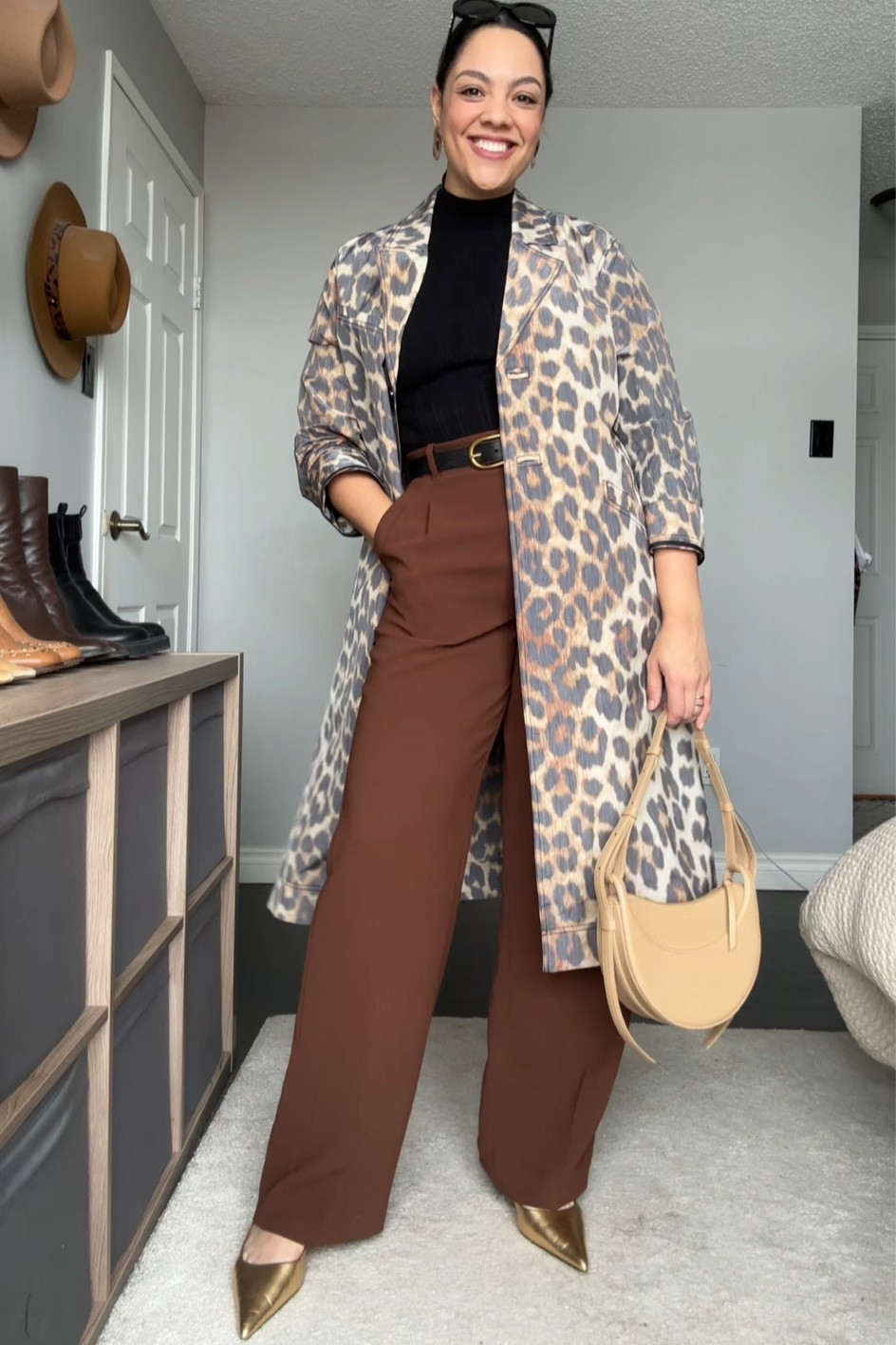 Styling a leopard print trench coat! Details below:
-Ganni leopard print trench coat. I have a size 40. 
-Abercrombie black Mockneck long sleeved top. I have a medium. 
-Aritzia high rise wide leg trousers in brown. I have a size 10 long. 
-Black belt with gold buckle. 
-Polène Paris numero dix bag in beige. 
-Gold slingbacks. 
-Celine Triomphe sunglasses. 

#LTKSeasonal #LTKstyletip #LTKMostLoved