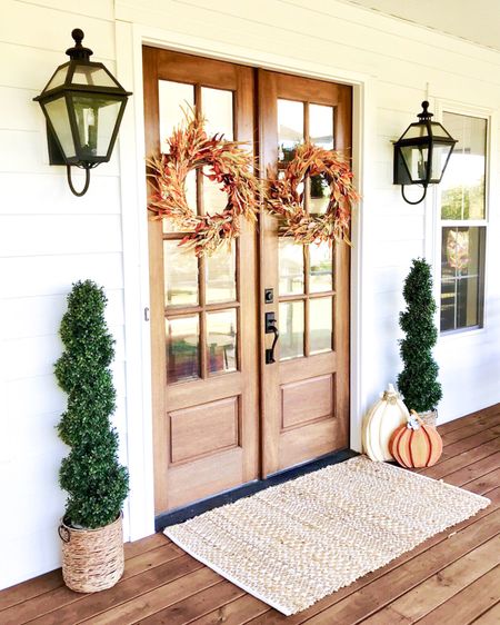 Front porch and door decor fall autumn harvest seasonal entry French double doors oversized layered scatter rug and doormat pumpkin magnolia trees faux artificial silk florals mums baskets wreaths outdoor lanterns wall sconces rocking chairs light fixtures southern modern farmhouse style home decor nearly natural amazon finds Etsy wayfair marshalls TJ Maxx home goods Walmart autumn oak trees 

#LTKSeasonal #LTKhome #LTKHalloween