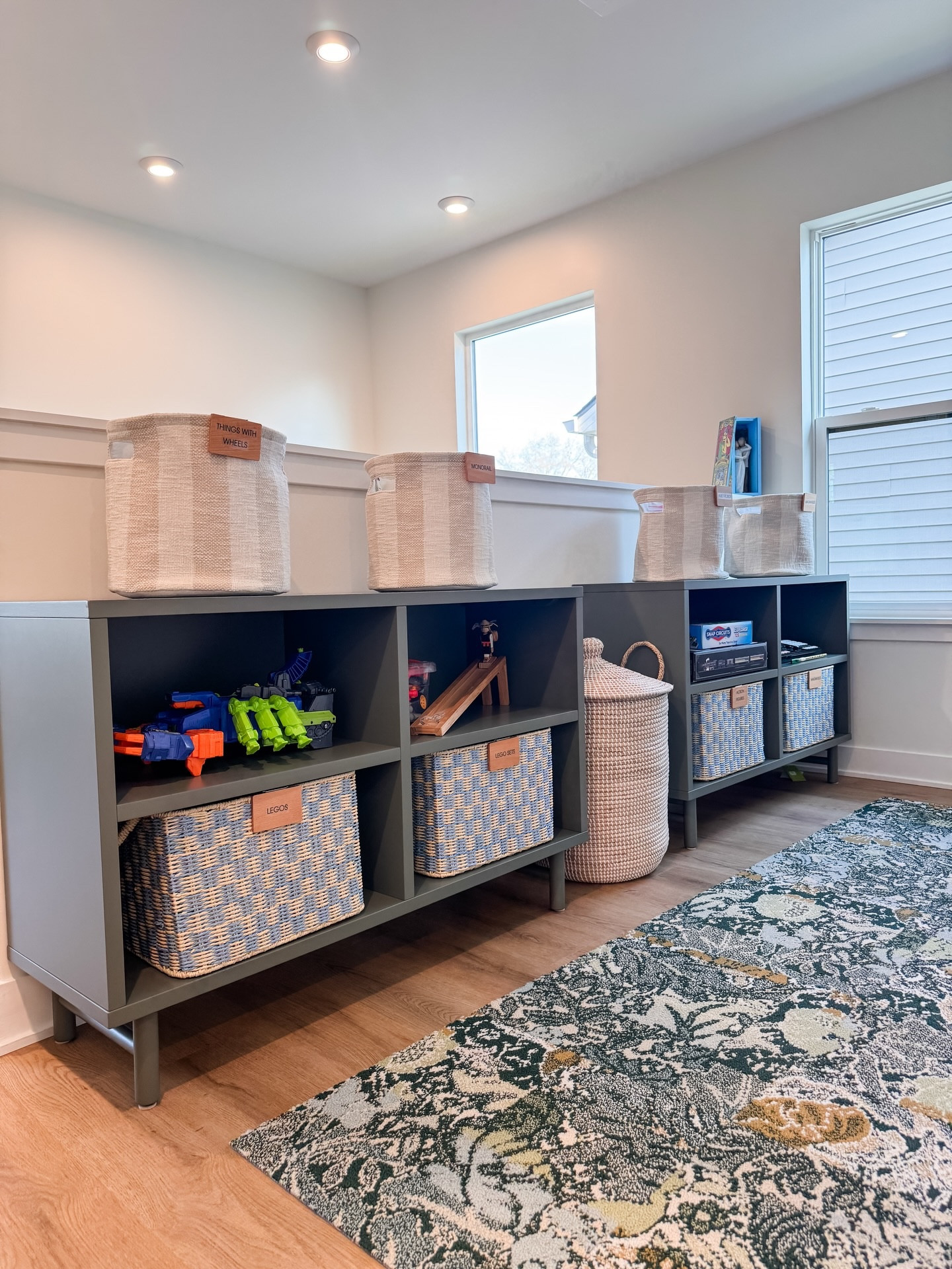 If this space doesn’t inspire P L A Y, we’re not sure what does! When our client reached out, she had two major goals:

1) Move toys out of the bedroom and into this sweet little top of the stairs nook.

2) Keep the tree bookshelf, but source pieces that transition from play to elevated storage as the kids age.

We love that our client was open to adding some color + pattern and feel like this mix of systems and product perfectly achieved the goals!