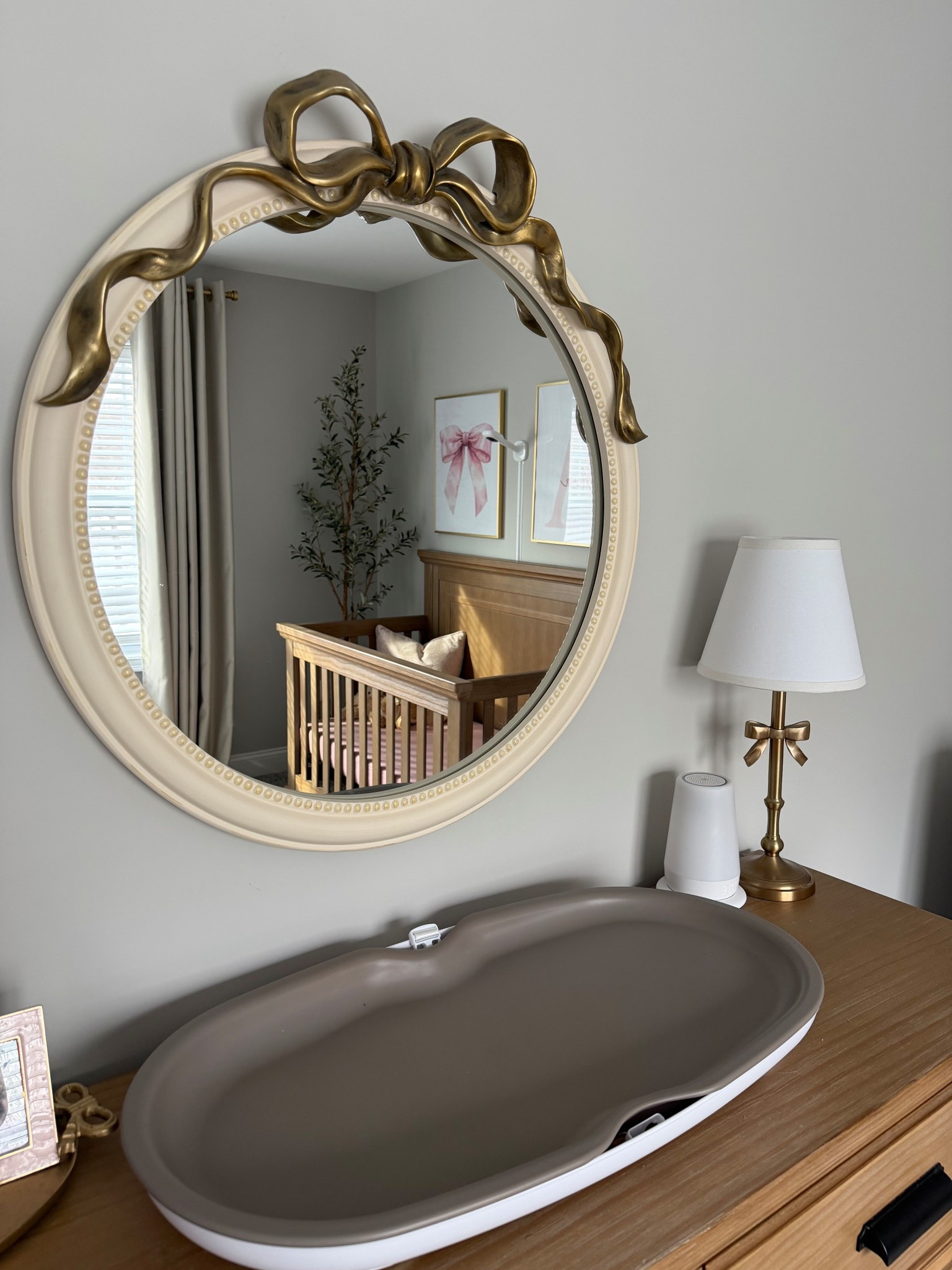 Baby girl nursery details 💞

Still obsessed with the gold bow mirror & lamp, soft wood tones and pops of pink 🙂

Mirror & lamp are from the Pottery Barn Kids Ava collection!

#LTKBaby #LTKHome #LTKmomlife