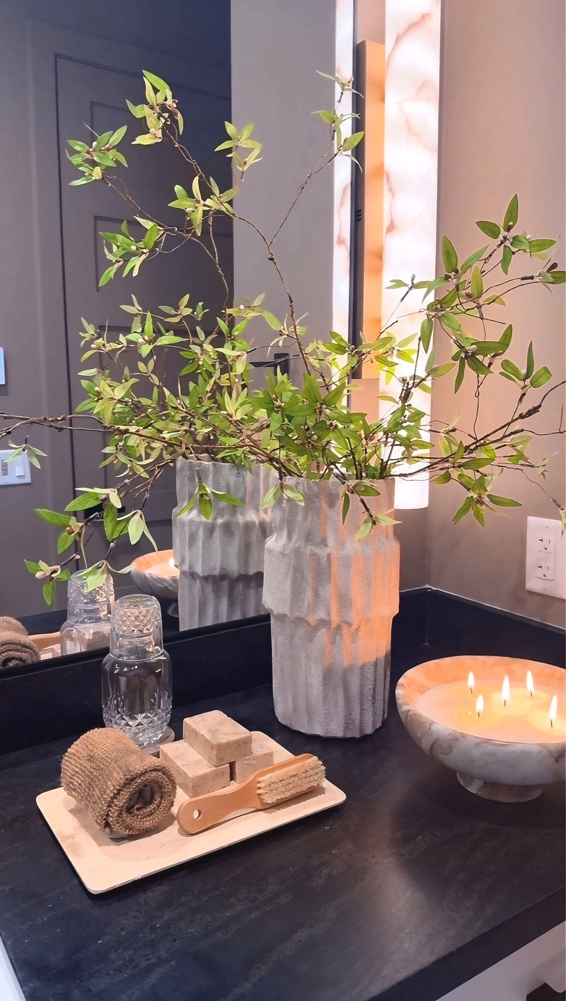 It’s the smallest details that turn a bathroom into a calming retreat. A textured vase with soft green stems adds a natural touch, while a marble bowl and travertine tray layer in those spa-like materials. Finished with a beautiful soap display, this simple table styling brings that quiet, spa feeling right into your home.

bathroom counter styling
spa bathroom decor
travertine tray decor
marble bowl decor
bathroom vanity styling 🕊️🌿

#summerthompsonstyles


#LTKHome #LTKselfcare #LTKU