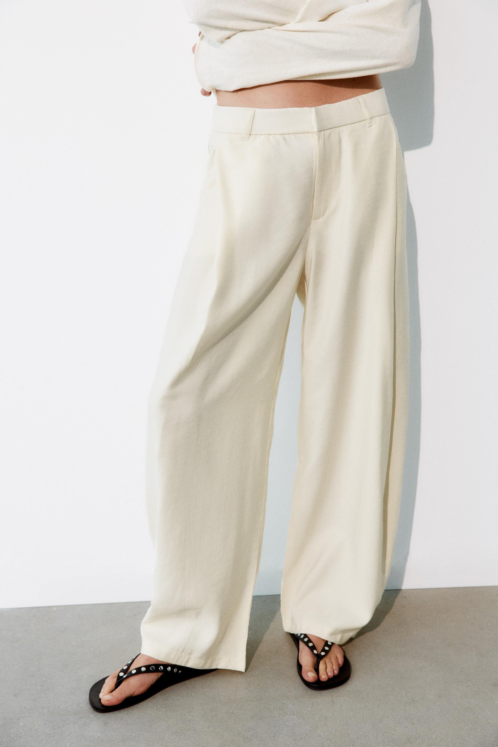 Flowing trousers featuring a high-waist with belt loops, side pockets, rear patch pockets, front ... | Zara UK