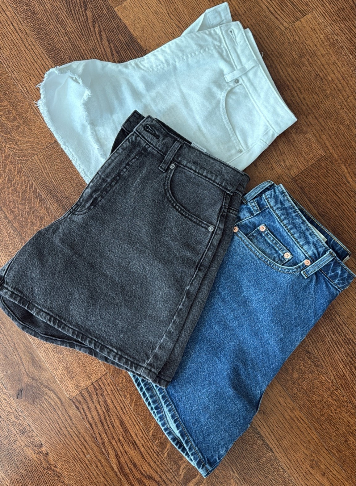 Size up in the white shorts, true size in black, size up if between in the blue denim!