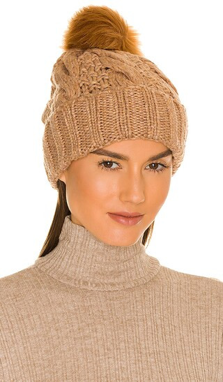 Knit Cable Beanie With Faux Fur Pom in Camel | Revolve Clothing (Global)