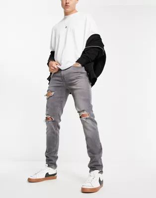 ASOS DESIGN skinny jeans in washed grey with heavy rips | ASOS (Global)