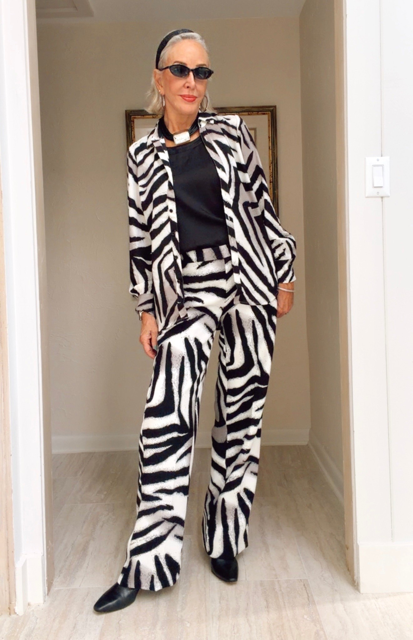 This soft, collared hi-low shirt is the must-have of the season. Pair with any bottoms in neutral or the matching bottoms (sold separately). 

Zebra print- French fashion-inspired Georgette fabric, known for its elevated, soft, and lightweight characteristics.
Classic-fit, collared, button down shirt with hi-low hemline.
I wear a size 0 in Chico’s unique sizing 
Bold statement necklace and silky tank in black. 
Wear booties, sling back shoes, or even sneakers work

#LTKOver40 #LTKgrwm #LTKSaleAlert