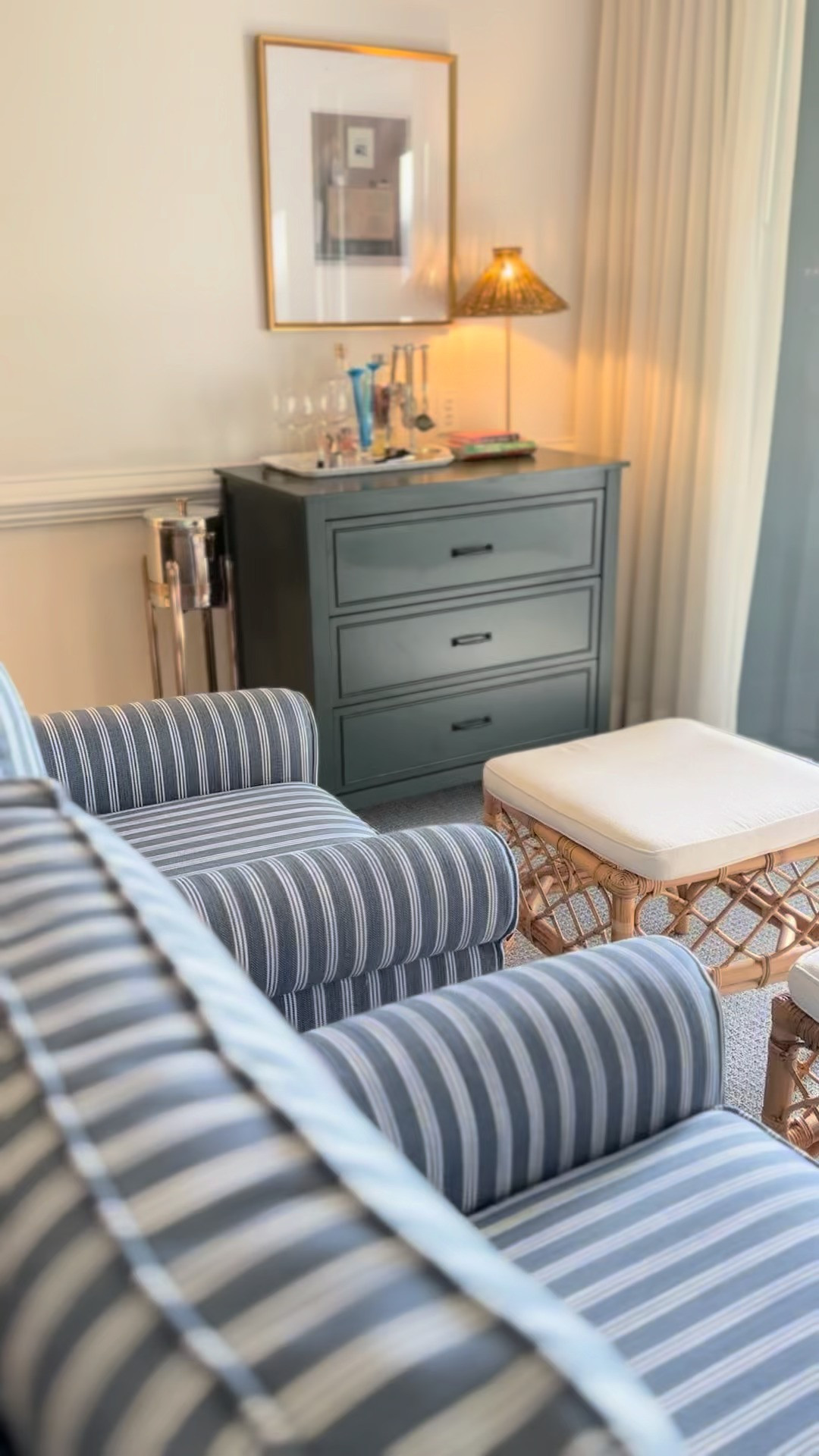 Let's take a mini tour of our condo's living room, starting with these striped swivel chairs—we love how easily they swivel to catch views of golfers passing by. Next up, we're using this dresser as our entertainment area, styling the top with some bar accessories and tucking away board games and puzzles neatly in the drawers. Now, let's hang some coastal art over my new sofa (also from Wayfair!). I absolutely love its reversible cushions and durable performance fabric—it's seriously perfect for curling up and unwinding at the end of the day.  Wayfair had everything we need to make the perfect, cozy living room.  #wayfair #wayfairpartner @wayfair   

 #LTKHome #LTKSaleAlert #LTKWatchNow