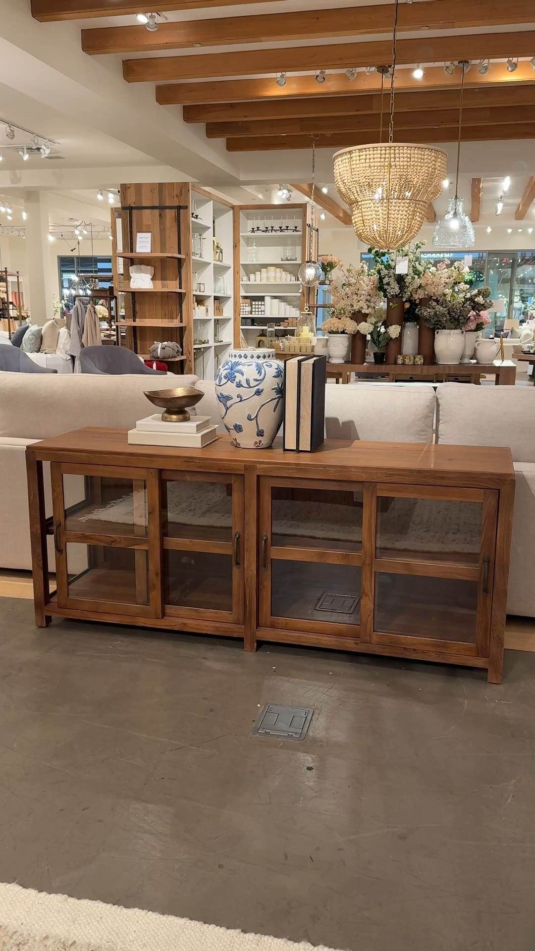 A warm, functional statement! 🤎 This reclaimed teak console table adds instant character with its rich, lived-in wood and thoughtful details. 💫 Styled behind a sofa, it’s perfect for layering decor—stacked books, a brass bowl, and a blue-and-white floral vase—while the glass-front cabinets keep things feeling light and styled (and hide extra storage beautifully). ☺️ One of those pieces that grounds a space and makes it feel complete without overpowering it. Linked this console along with other similar styles to recreate this cozy, curated look! ✨ #LivingRoomInspo #Sideboard #PotteryBarn

#LTKHome #LTKSaleAlert