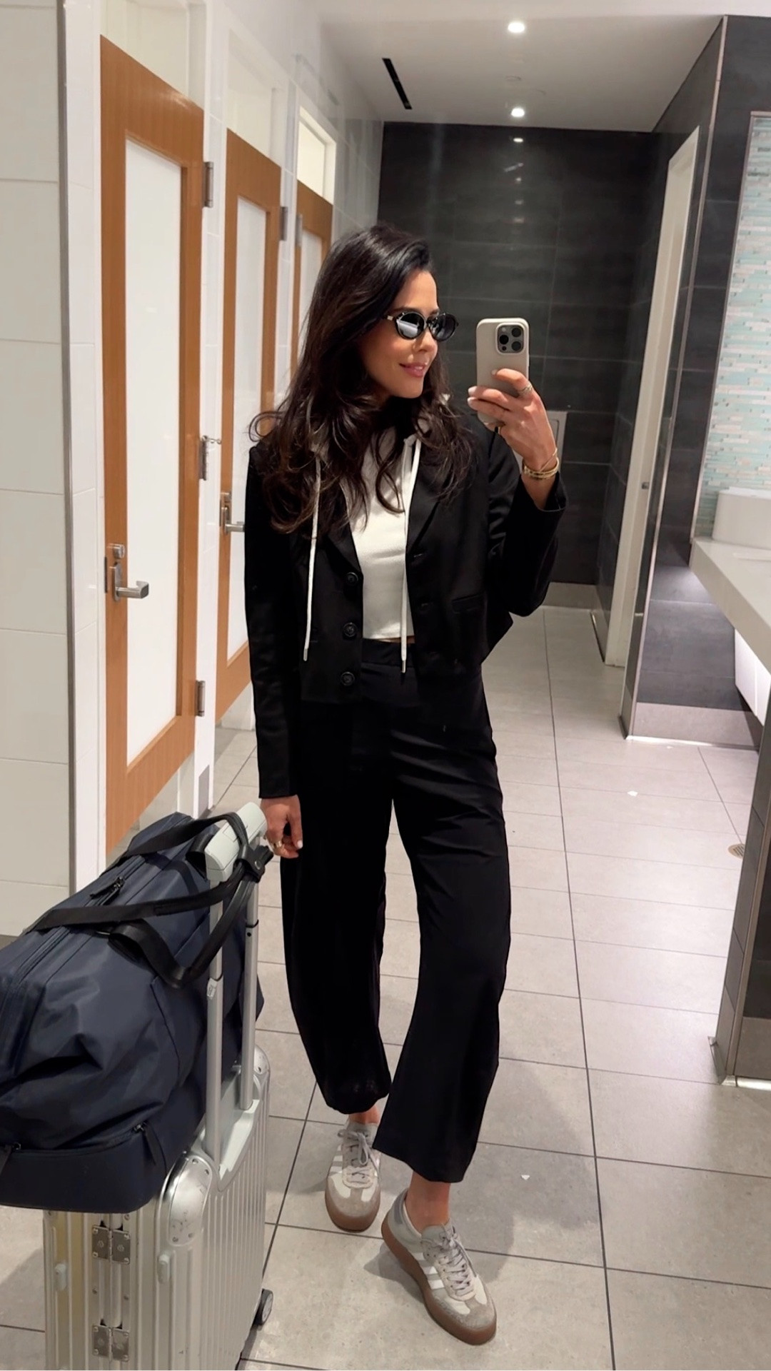 The kind of travel outfit that feels like loungewear but still looks elevated. These barrel pants are my go-to for every flight — stretchy elastic waist, insanely comfortable, zero wrinkles, and worth every penny. I did find a dupe version, but this pair is the investment piece I keep reaching for.

Paired with a classic white tank, Adidas sneakers, and my newest obsession: this blazer with the built-in hoodie detail. It gives chic layered look energy while feeling as cozy as a sweater. The perfect mix of comfortable + polished for travel days.
Vivrelle code: DianaCarolina for 1 month free.