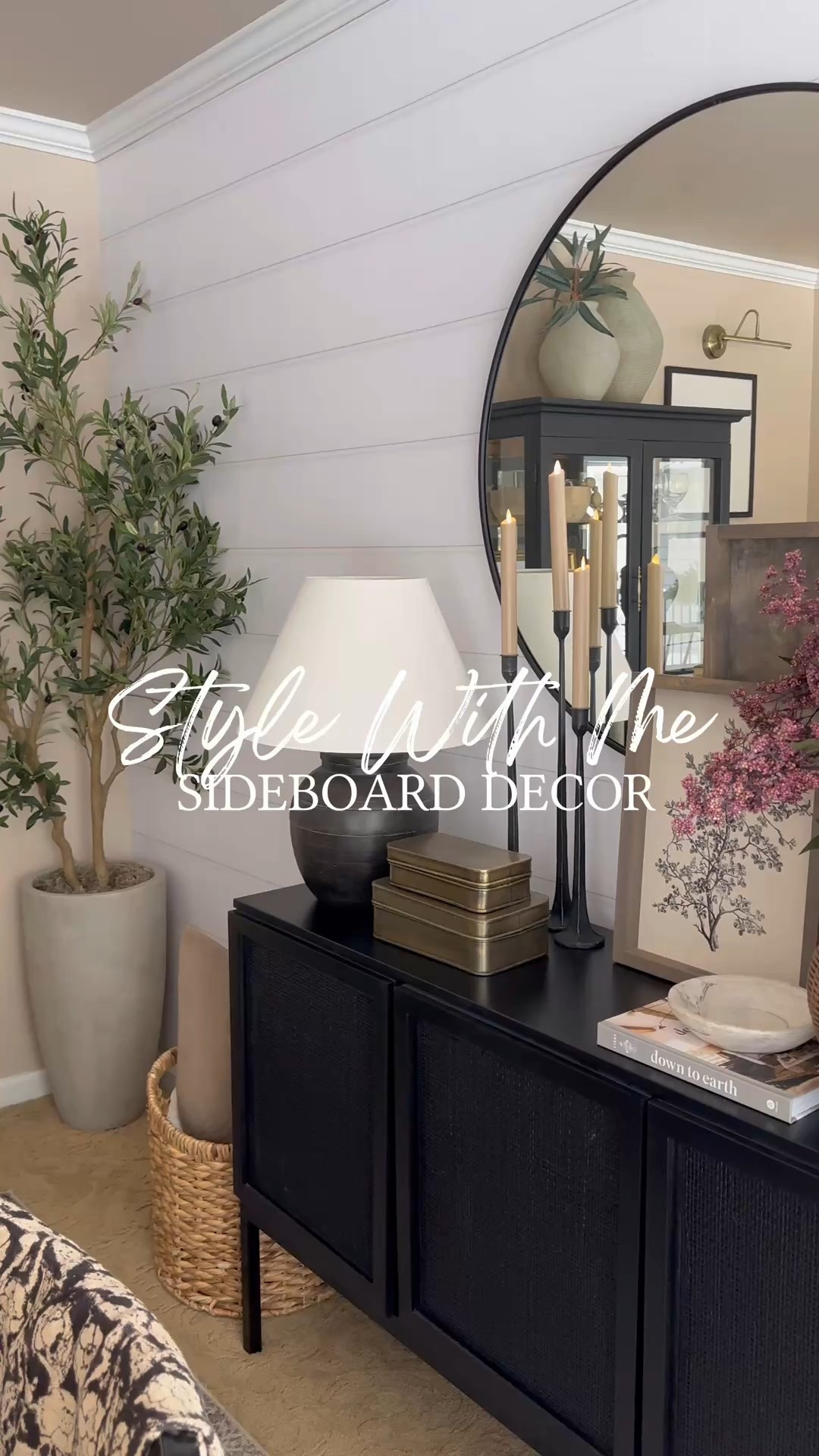 Modern Organic Sideboard Decor with Round Black Mirror

Follow @farmtotablecreations on Instagram for more cozy home inspiration.

This sideboard vignette brings together warm neutrals, layered textures, and timeless accents for a clean modern organic look. The round black mirror adds depth and contrast, while stacked art, soft candlelight, and a woven wicker vase filled with faux berry stems keep the styling grounded and inviting. It’s a simple way to create a statement moment without overwhelming the space—perfect for a dining room, entryway, or living area.

The build-a-sign frame feature is 15% off with my code FARMTOTABLE.
For reference:
Botanical Print 12x16
Abstract Art 24x24
Both in Briarsmoke stain
Five stems shown in vase  

#sideboarddecor #roundmirror #consoledecor #modernorganic #neutraldecor #homedecor #interiorstyling #wovenaccent #candlesticks #wallart



#LTKSaleAlert #LTKFindsUnder50 #LTKHome