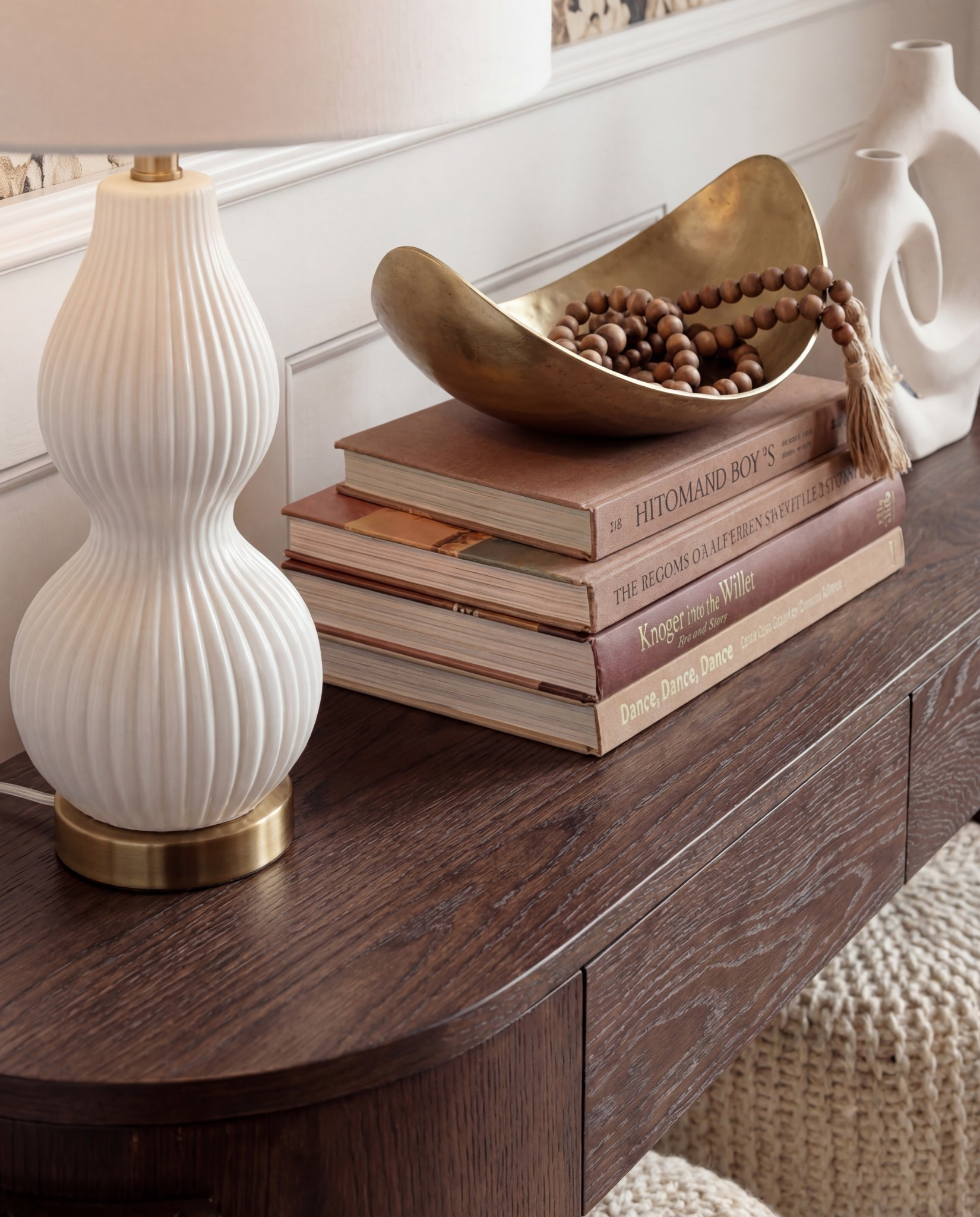 Shop the Look:
• Dark wood console
• Chunky knit ottomans
• Brass globe sconces
• Sculptural white lamp
• Floral wallpaper (cream/taupe/charcoal)
• Neutral geometric runner
• Gold bowl + white sculptural vase
• Design book stack

#LTKCyberWeek #LTKHome #LTKSaleAlert
