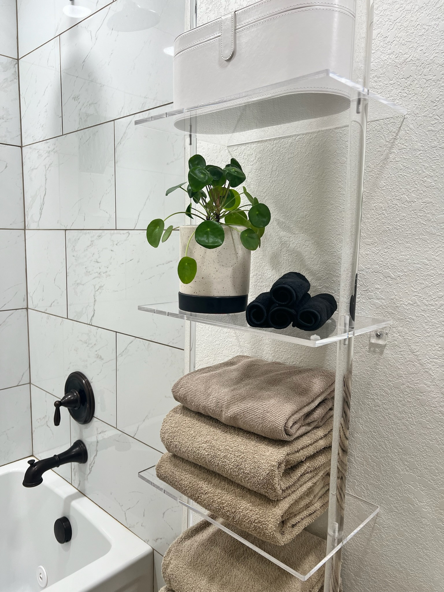 I love the airy look of this acrylic ladder shelf for our bathroom. I wanted the focal point to be the tile in the shower rather than the shelf itself. 

#LTKHome #LTKFamily