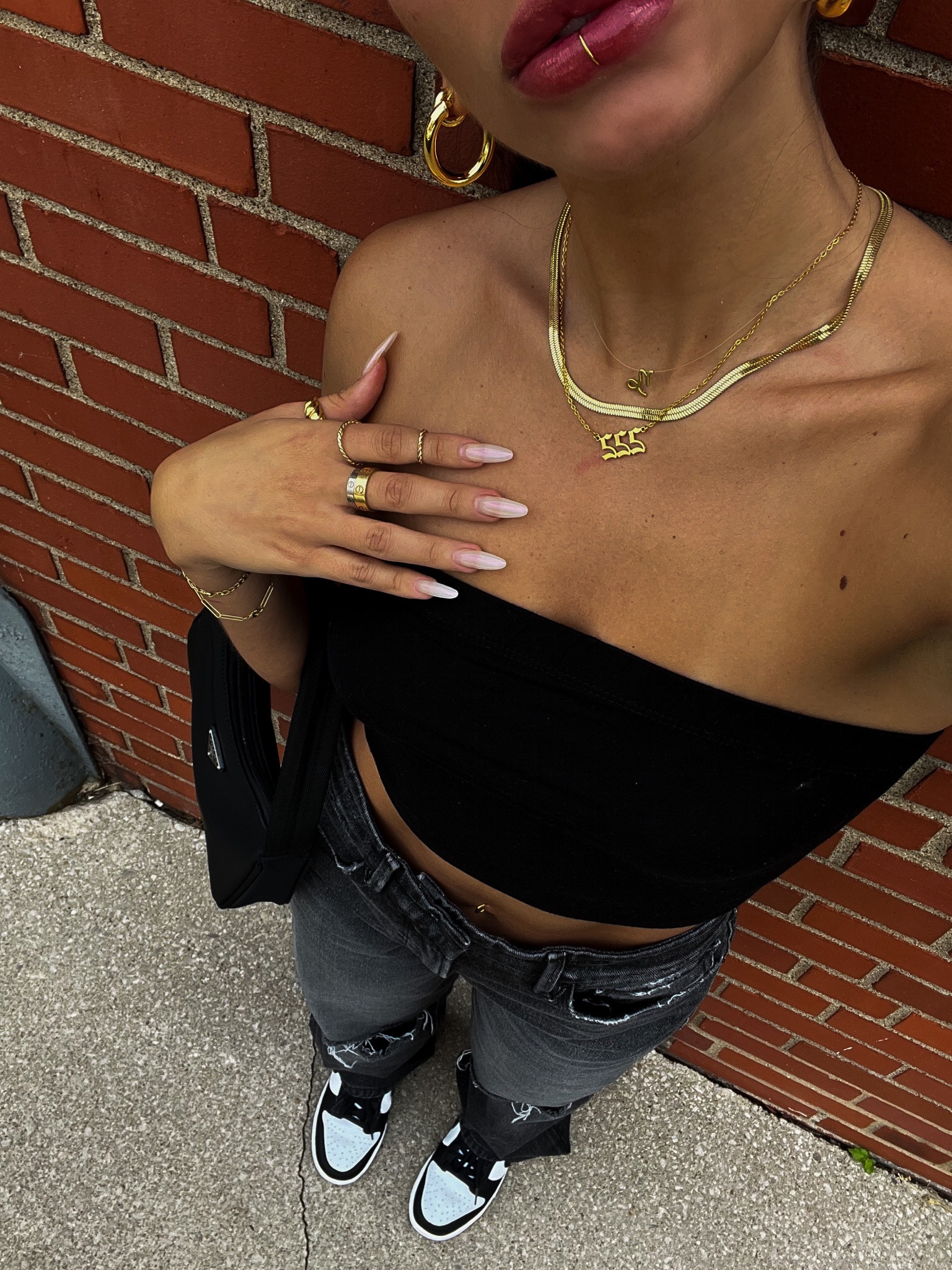 OOTD is a black moody moment. 

Neck: layered gold chain necklaces featuring zodiac sign necklace, angel numbers necklace, and my favorite snake chain gold choker. These are SO affordable and haven’t tarnished! 

Ears: my FAVORITE gold hoop earring combo. The oval hoops are the perfect twist for every day and the little chunky hoops are the perfect size and width. 

Body: black good American 90s style jeans paired with a simple black tube top, Nike dunks and Prada re-edition purse. 

Hand: my every day dainty gold bracelets and Cartier love rings, accessorized with the Mejuri croissant ring and a few dainty gold rings. 

Last is my faux lip ring. I’m loving this little piece lately 😍

#LTKstyletip #LTKSeasonal #LTKunder50