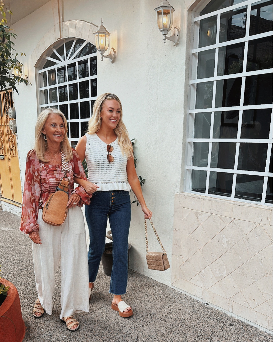 Strolling with my twin (aka mom), both of us head to toe in Pink Lily 💕👯‍♀️ 

Tops are both size SMALL
Bottoms are size SMALL & 26 
Sandals are size 7