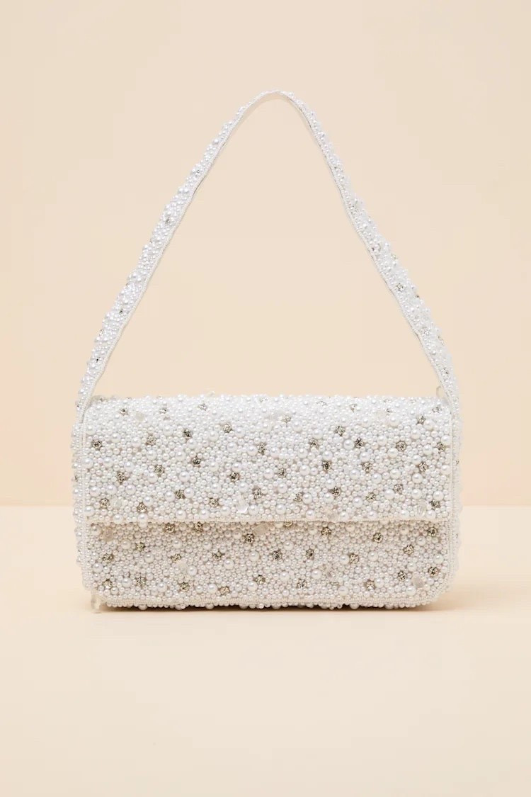 The Vivi White Pearl Rhinestone Shoulder Bag features pearl embellishments, rhinestone detailing, and an elegant shoulder silhouette that pairs beautifully with formal and occasion looks. Under $60.

Keywords:

* pearl shoulder bag
* rhinestone handbag
* white evening bag
* embellished purse
* formal shoulder bag
* pearl handbag
* bridal accessories
* special occasion bag
* pearl embellishments
* rhinestone detailing
* textured accessories
* elegant craftsmanship
* statement accessories
* luxe detailing
* refined finishes
* glamorous accents
* wedding guest accessories
* bridal shower outfit
* date night accessories
* evening event style
* graduation accessories
* girls night outfit
* cocktail party look
* celebration outfit

#LTKgrwm #LTKdayinmylife #LTKWedding