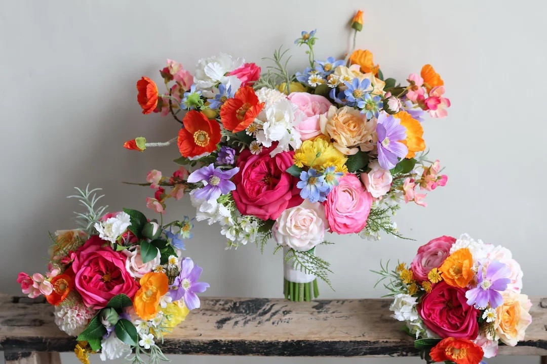 This vibrant wedding bouquet bursts with cheerful color, featuring a joyful mix of yellow, orange, hot pink, light blue, white, and purple faux blooms wrapped in elegant satin ribbon. The playful blend of textures and realistic “real touch” flowers creates a lively arrangement that’s perfect for spring and summer celebrations. Custom color options and matching pieces make it easy to design a coordinated wedding look you’ll love. 💐 #LTKwedding #colorfulwedding #bridalbouquet #fauxflowers #springwedding #summerwedding #weddinginspo #floraldesign

#LTKWedding #LTKHome #LTKSeasonal