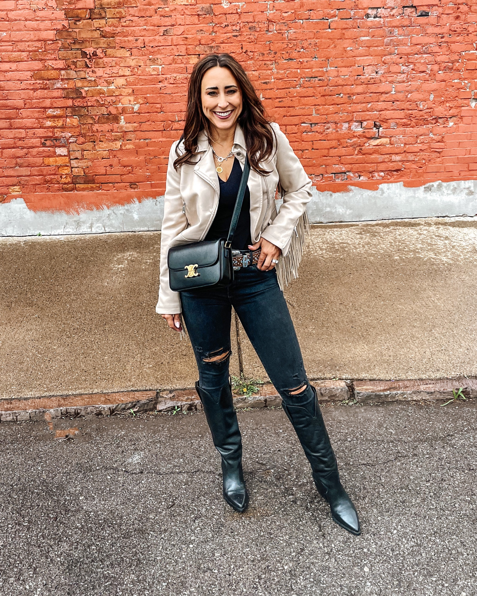 Nashville outfits, Country concert outfit, Black western boots, tall boots with black denim and cream fringe jacket. 
Denim TTS
Jacket linked similar. Exact is also Nasty Gal. 
Belt not available. It’s an old but such a goody! Will try to find similar. 
Boots TTS 

Western style, ranch style, Nashville, country concert, country festival, music fest 

Western boots cowboy boots
Nashville
Boots and dress
Country boots and dress
White dress
Western style
Music festival look
Country concert outfit 
Festival outfit 
White romper 
Show me your mumu 
Western belt 
Western look
Travel out west outfit
Ranch style
Horse girl style

#LTKU #LTKstyletip #LTKSeasonal