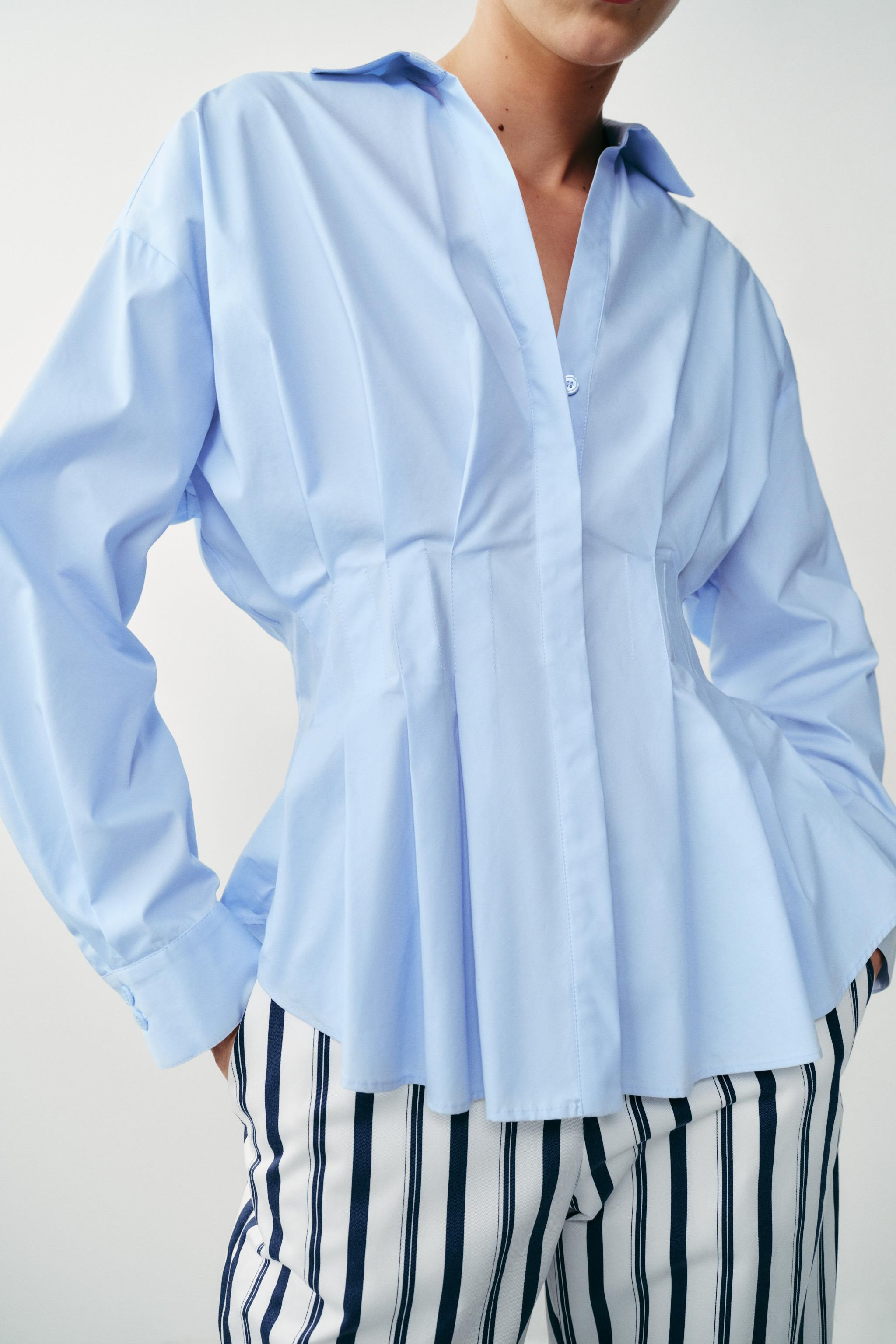 Collared shirt with a V-neck and long sleeves. Featuring pleat detailing at the waist. Front clos... | Zara US