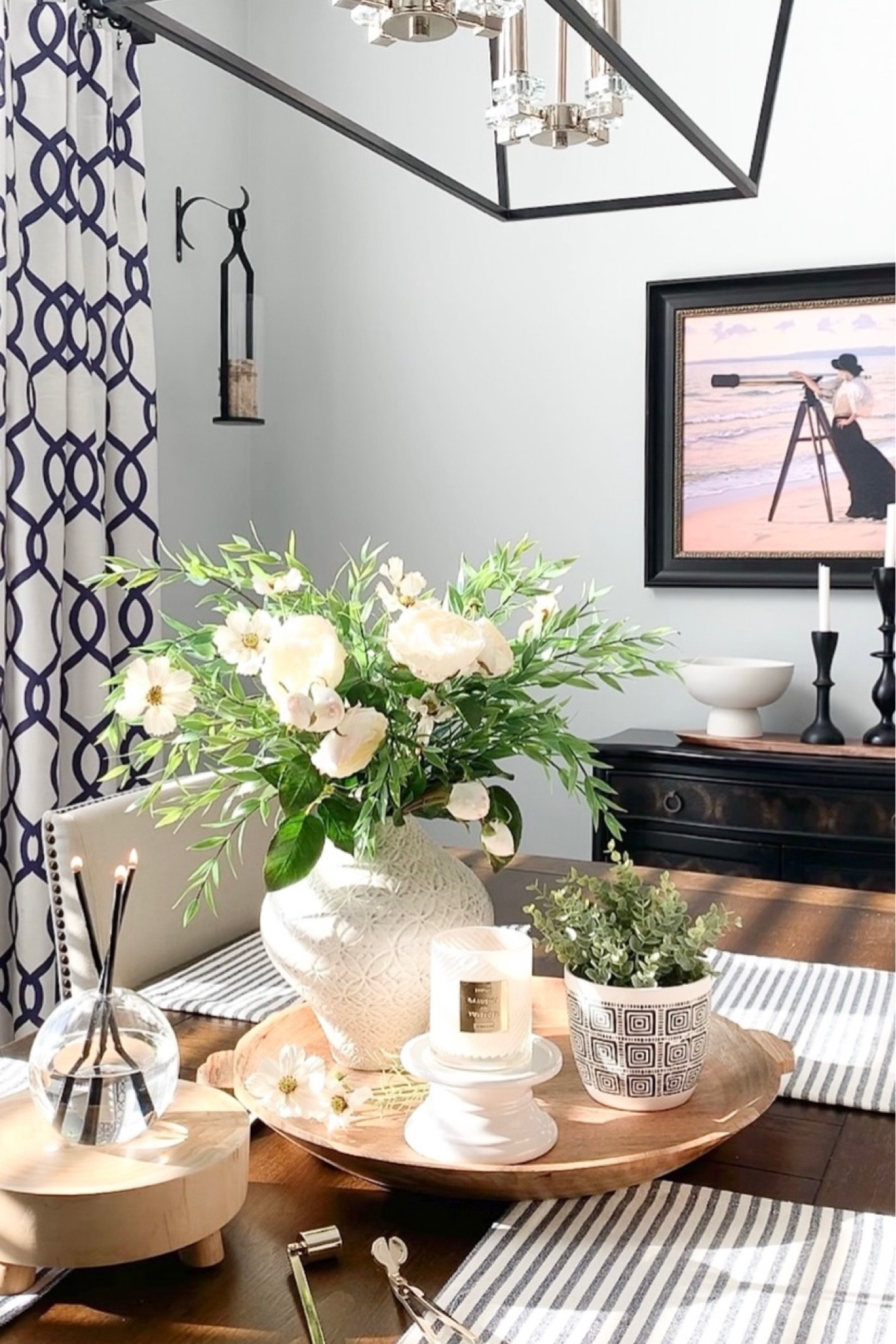 Spring transition with beautiful white roses, Blue and white curtain panels on sale, black cabinet on sale, Cosmo florals with greenery, favorite textured vase, black candleholders on sale, candle accessories, everlasting candle, wood tray back in stock, Seagrass tray, pedestal bowl, wood riser. Home decor accessories, interior styling. 

#LTKhome #LTKsalealert #LTKunder50