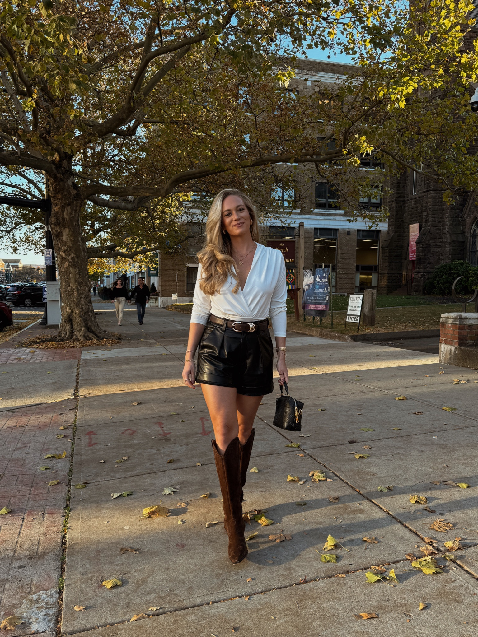 Fall outfit, fall date night outfit wearing Abercrombie top with leather shorts and dark chocolate brown dolce vita boots 