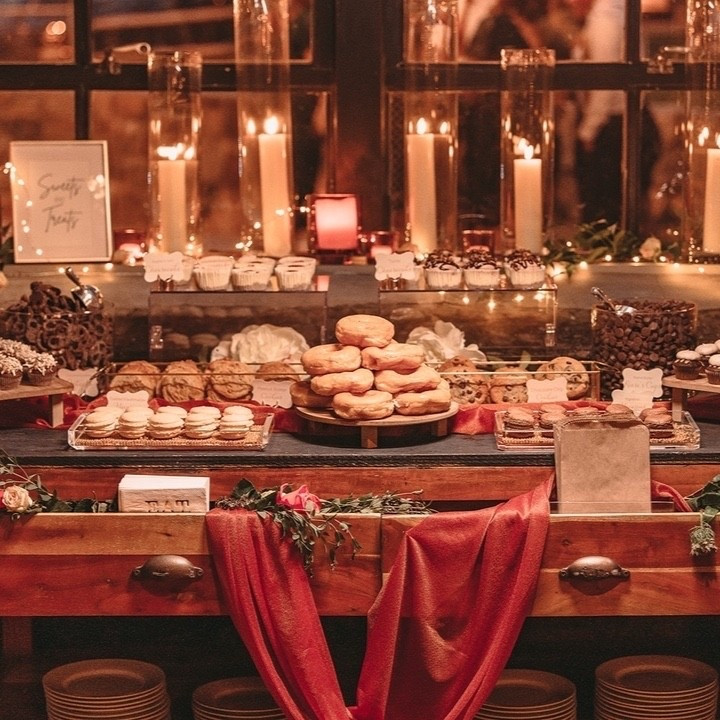 Imagine a wedding reception bathed in the soft glow of candlelight, where every flicker casts a warm, golden hue over your celebration ✨ A dessert table adorned with rich burnt orange tones, decadent chocolates, lush greenery, and deep earthy browns, creating a mood that’s as romantic as it is dreamy. It’s the perfect setting to savor every sweet bite and every intimate moment. If you’re planning your wedding, this is the vibe you won’t want to miss.