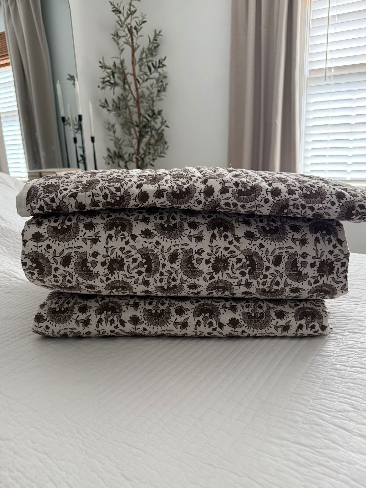 Look for less bedding set!
Reminds me of something from Magnolia- but for a fraction of the price!!!

•Quilt set in a floral block print pattern 
•Neutral colors- ivory background with shades of browns 
•available in twin, queen or king 
•I have the king - comes with the sham(s) too!

Accent lumbar pillow also available (and linked)

#LTKHome #LTKSeasonal #LTKStyleTip