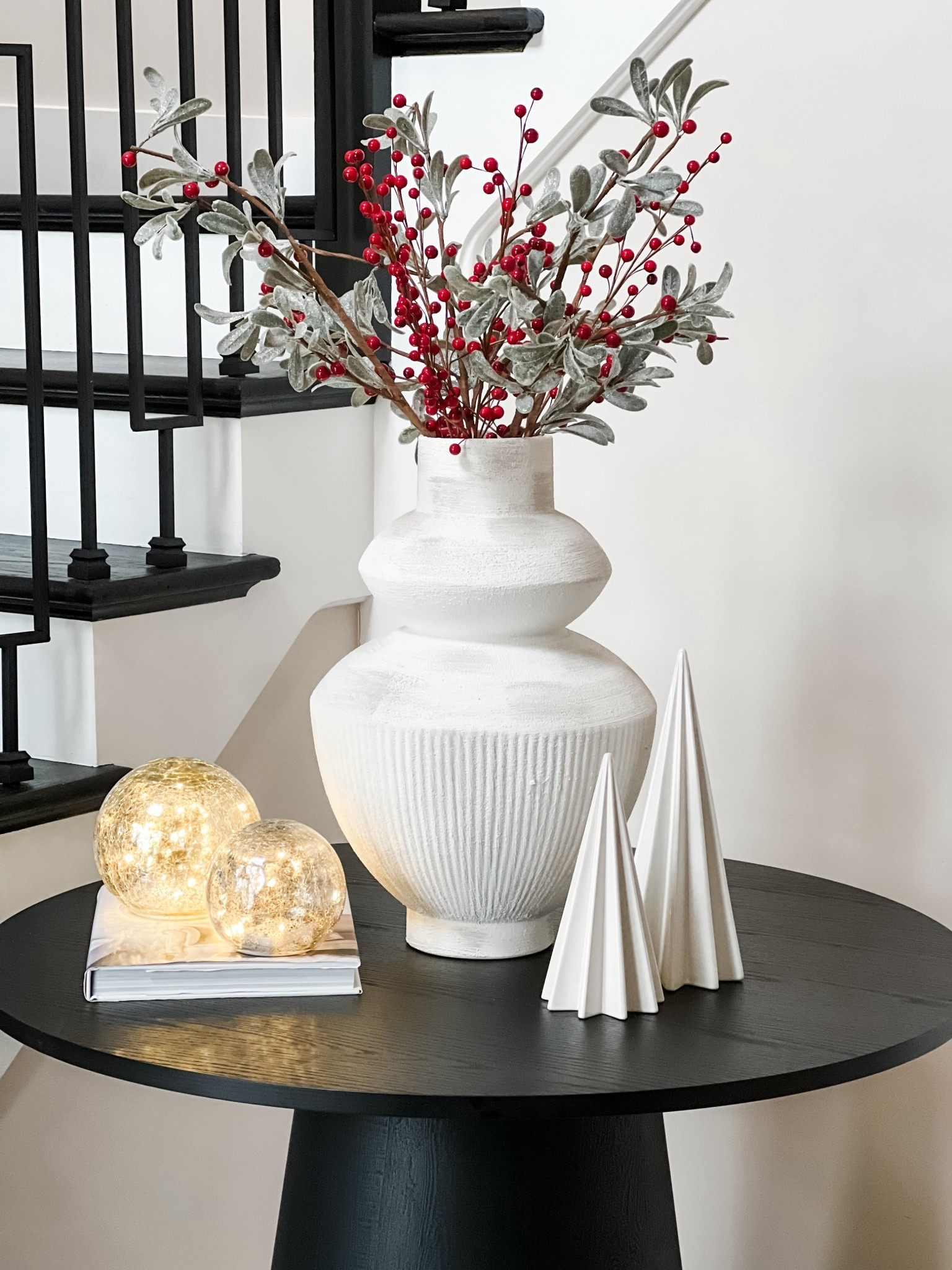 A little holiday magic in the foyer ✨ loving this Crate & Barrel vase with winter stems and soft twinkle lights.

#LTKFindsUnder100 #LTKHome #LTKSeasonal