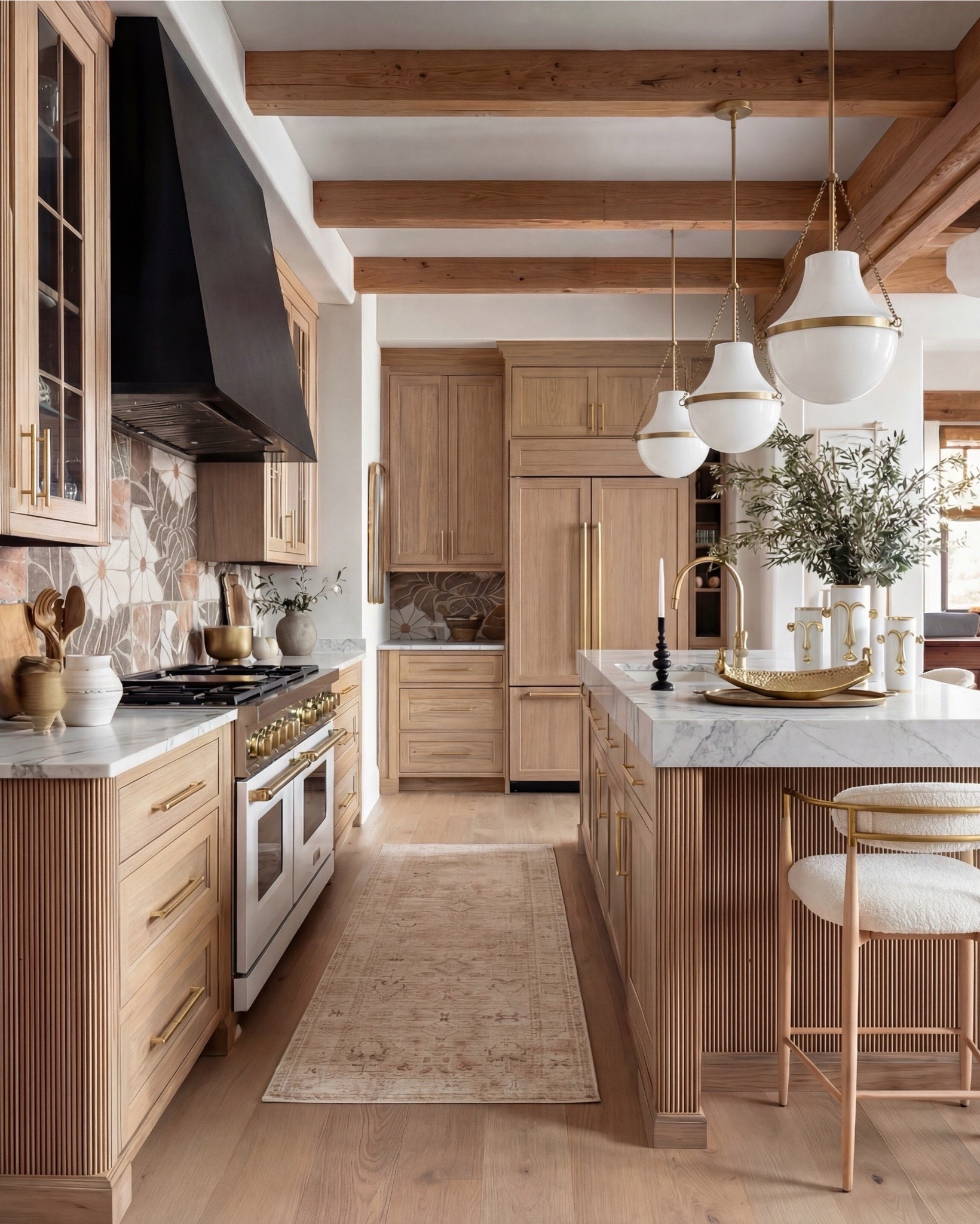 This kitchen is the definition of warm luxury done right. The natural oak cabinets, fluted island detailing, and marble counters create that soft, elevated palette everyone’s obsessed with right now. And can we talk about the pendants? Those sculptural white + brass beauties pull the whole space together.

The mixed-tone floral backsplash adds the perfect touch of personality without overwhelming the room, and the white range with brass hardware… she’s the star. Layered marble, muted runner, boucle bar stools, and gold accents make everything feel curated but still livable.

Shop the Look:
• Natural oak cabinetry (with fluted island detail)
• White + brass sculptural pendant lights
• White gas range with brass trim
• Warm floral tile backsplash
• Boucle + brass bar stools
• Marble countertops (soft veining)
• Brass kitchen hardware
• Ceramic vases + stone serveware
• Neutral vintage runner
• Gold tray + candle holders
• Oak beams (warm rustic contrast)

#LTKSaleAlert #LTKSpringSale

#LTKsale #LTKhome