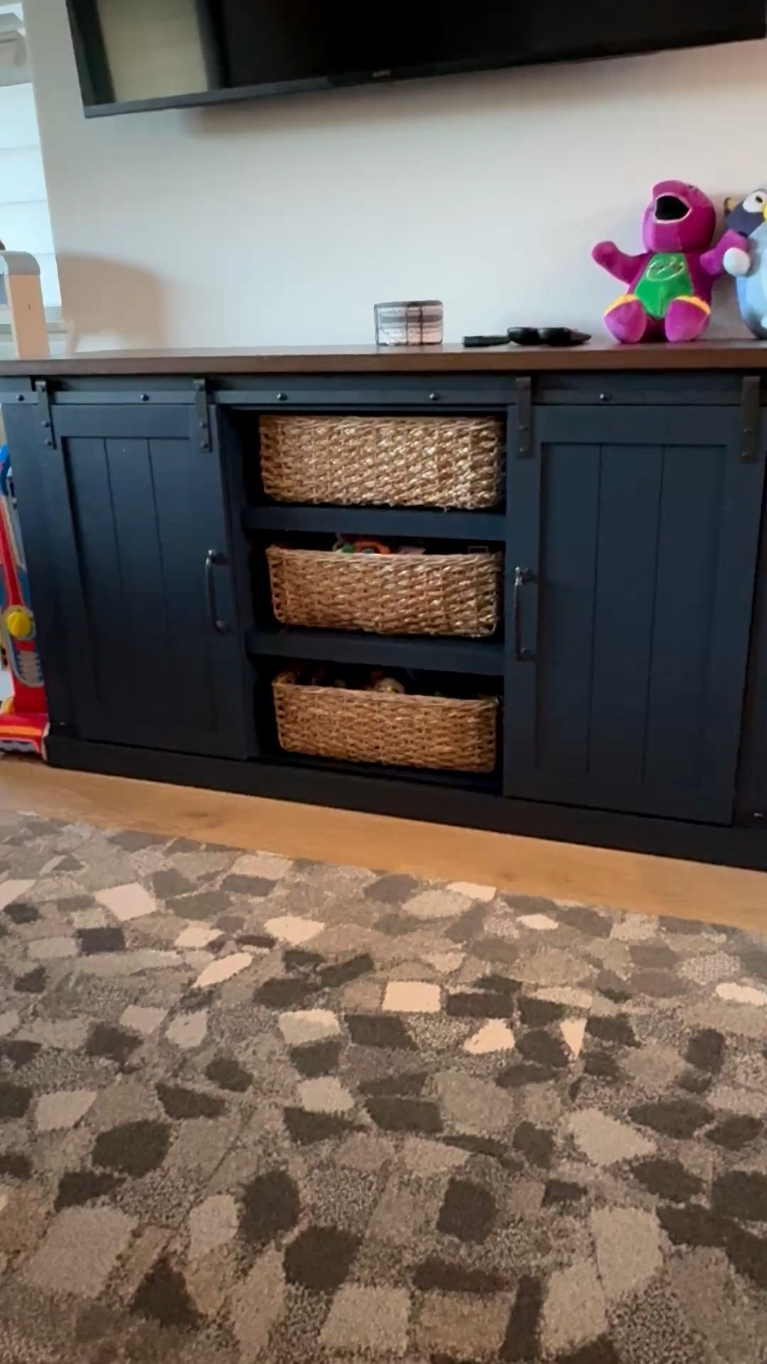 Living room toy storage organization made simple! I added these woven basket storage bins to our navy blue TV stand to neatly hide my son’s growing toy collection while keeping our space looking clean and elevated. Our living room doubles as a playroom, so I’m always finding stylish ways to conceal toys without sacrificing design. Bonus: even more storage is tucked behind the cabinet doors.

#LTKHome #LTKKids #LTKmomlife