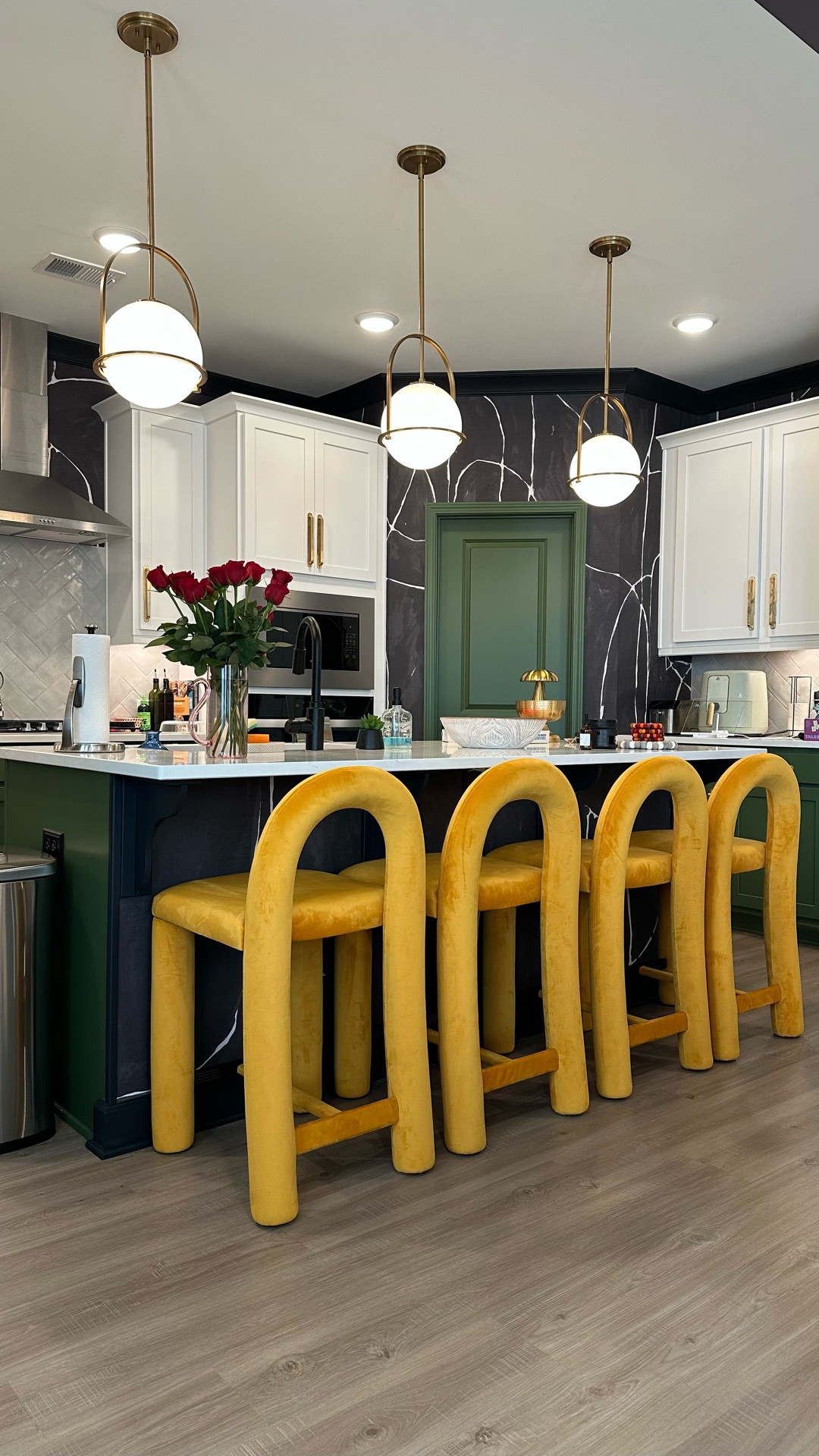 Bold and colorful kitchen with black wallpaper, yellow counter stools, and globe kitchen pendant lights

#LTKHome