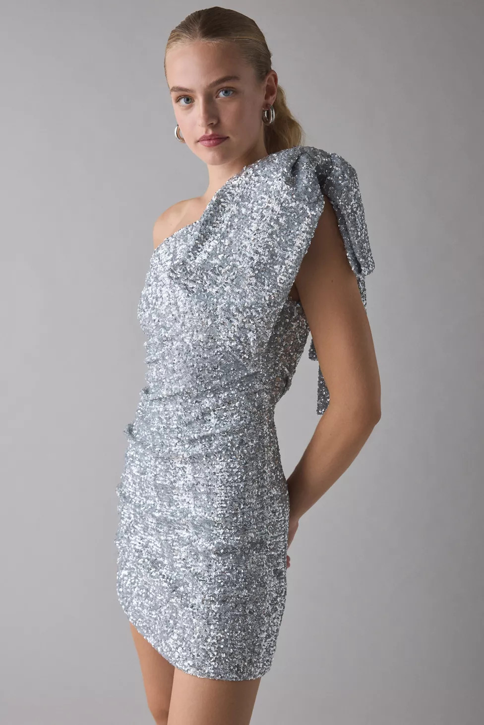 Glamorous Silver Sequin One-Shoulder Bow Mini Dress | Urban Outfitters (US and RoW)