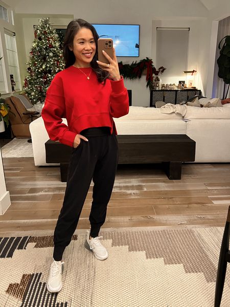 Holiday athleisure outfit with a bright red cropped pullover, black high waisted joggers that are maternity friendly and white sneakers  

#LTKsalealert #LTKHoliday